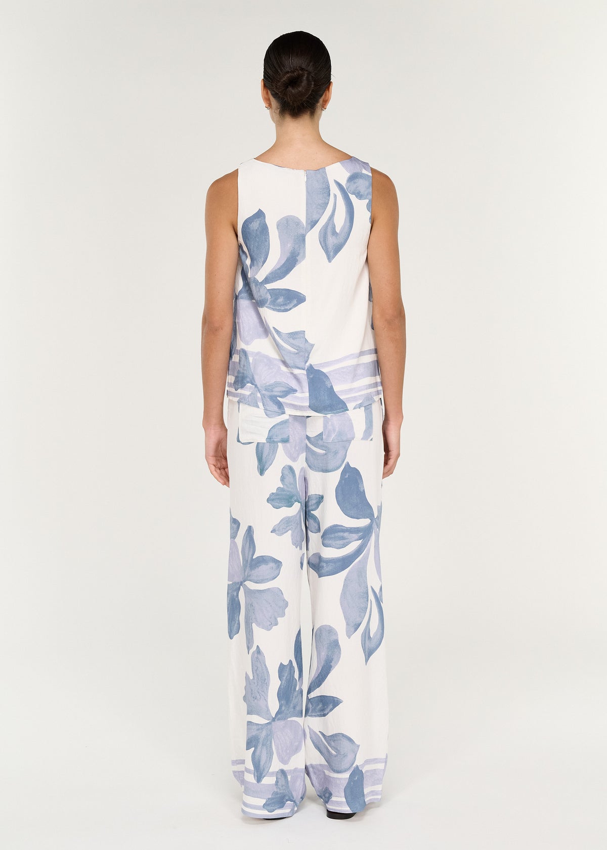 Boatneck Sleeveless Top in Blue Floral worn with matching Elody pant, showcasing the relaxed fit and floral print.