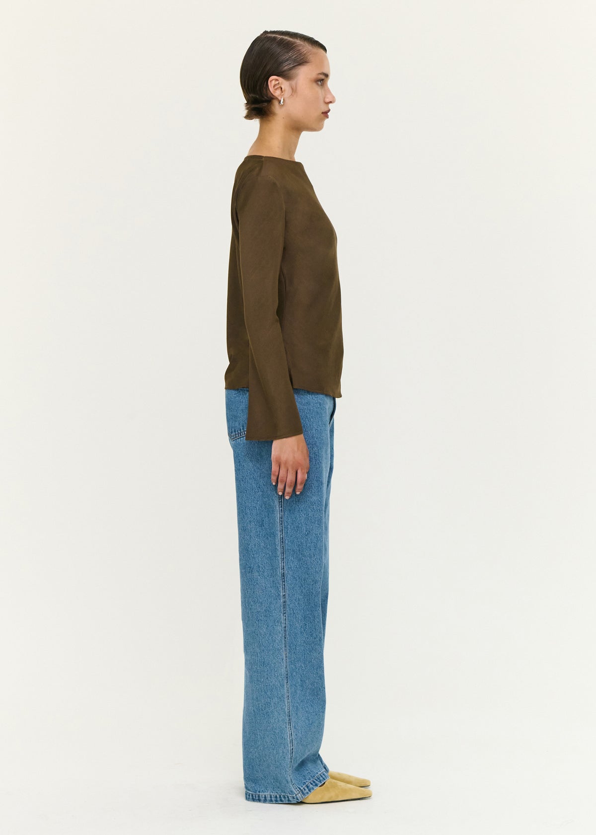 Side view of the Espresso Bias Cut Boat Neck Top, showing a hip-length hemline and a soft woven fabrication.