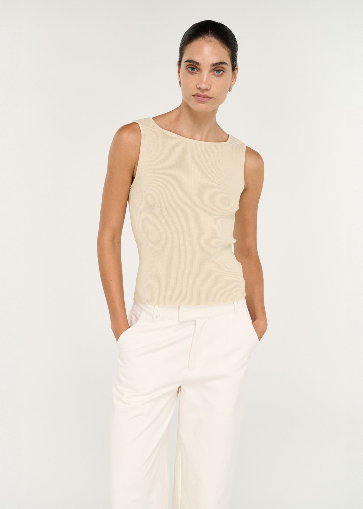 Model wearing Fine Rib Knit Reversible Tank in Ecru with a fine ribbed knit fabrication and a reversible design.