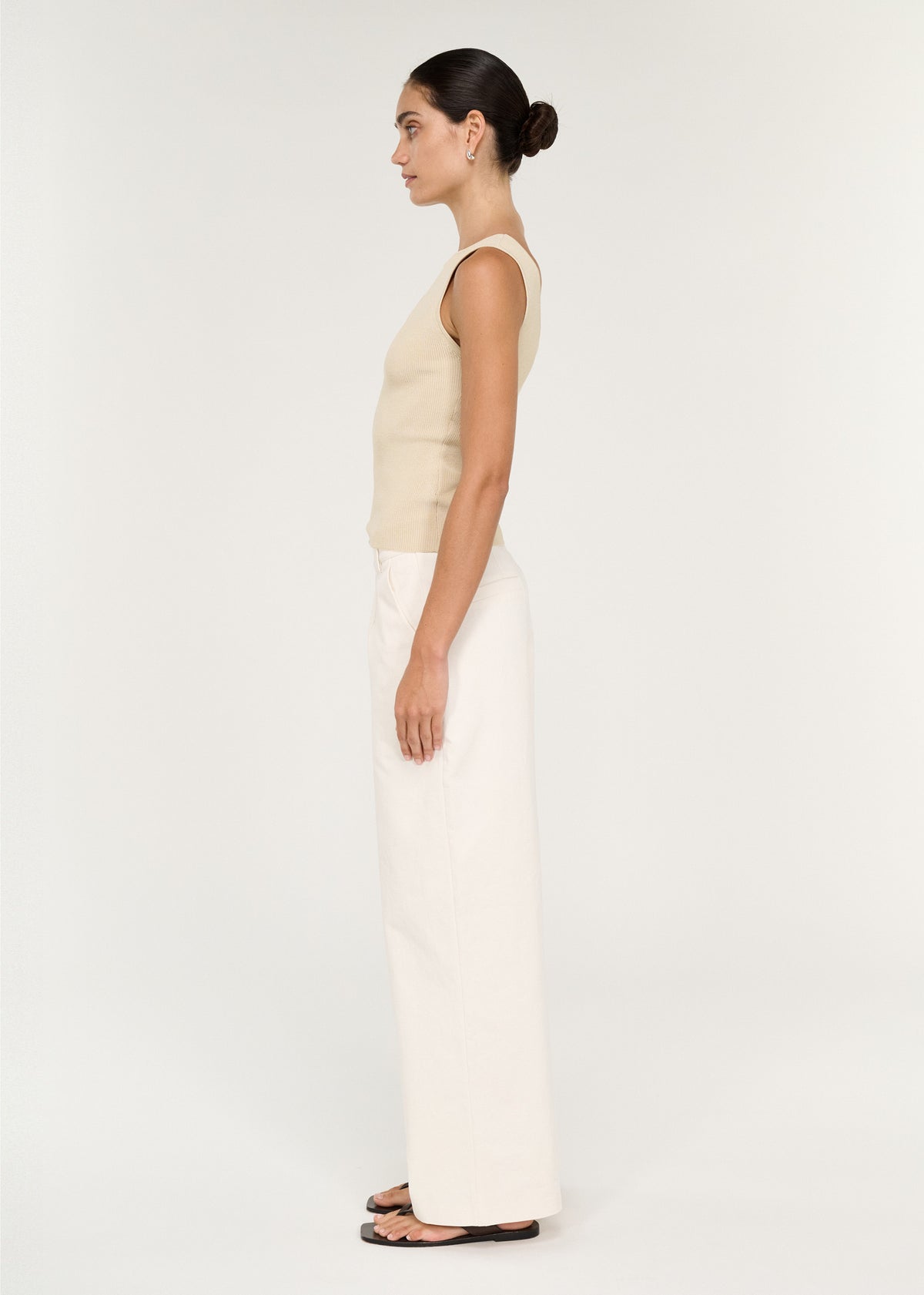 Side view of the Fine Rib Knit Reversible Tank in Ecru, showing a sleeveless cut and a hip length.