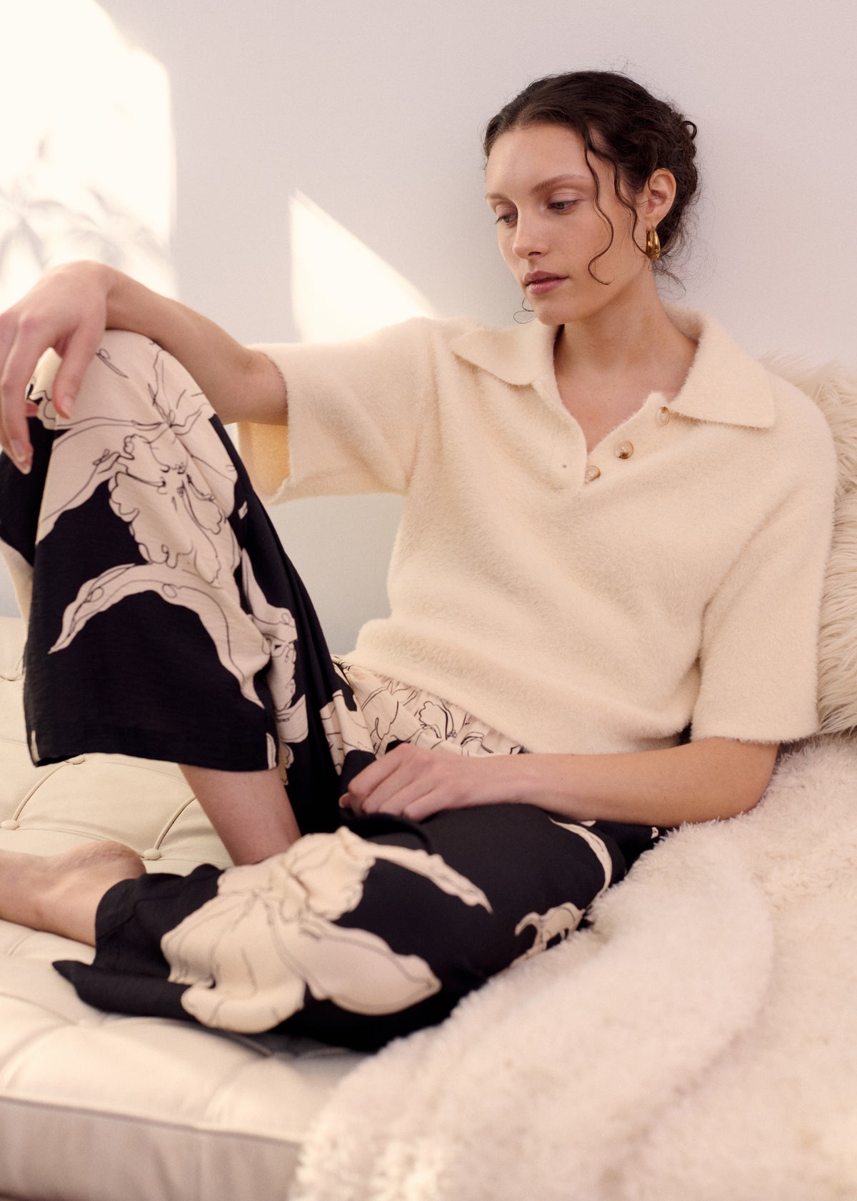 Model seated wearing Fluffy Knit Polo Top in Cream with elbow-length sleeves and a slightly cropped length.