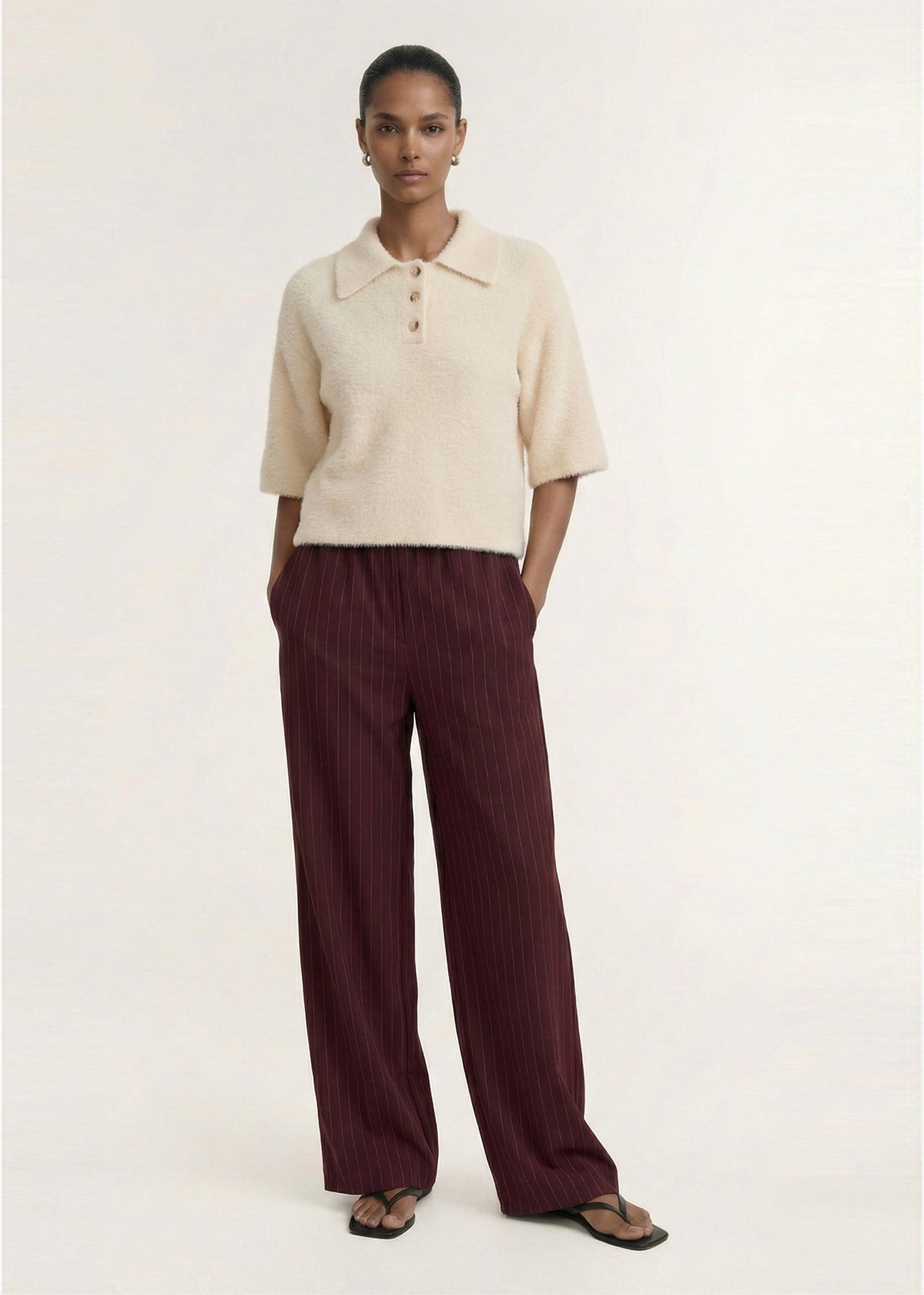 Model wearing Fluffy Knit Polo Top in Cream, showing a ribbed hem detailing and a plush hand feel.