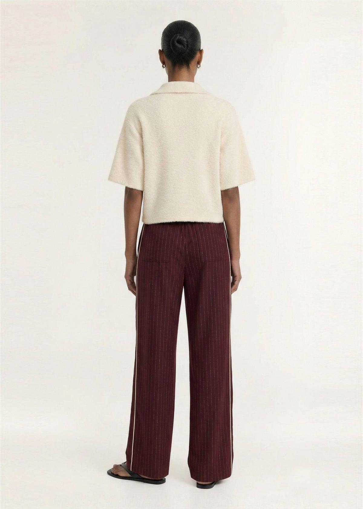 Back view of the Fluffy Knit Polo Top in Cream with a button front placket and a soft textured knit fabrication.