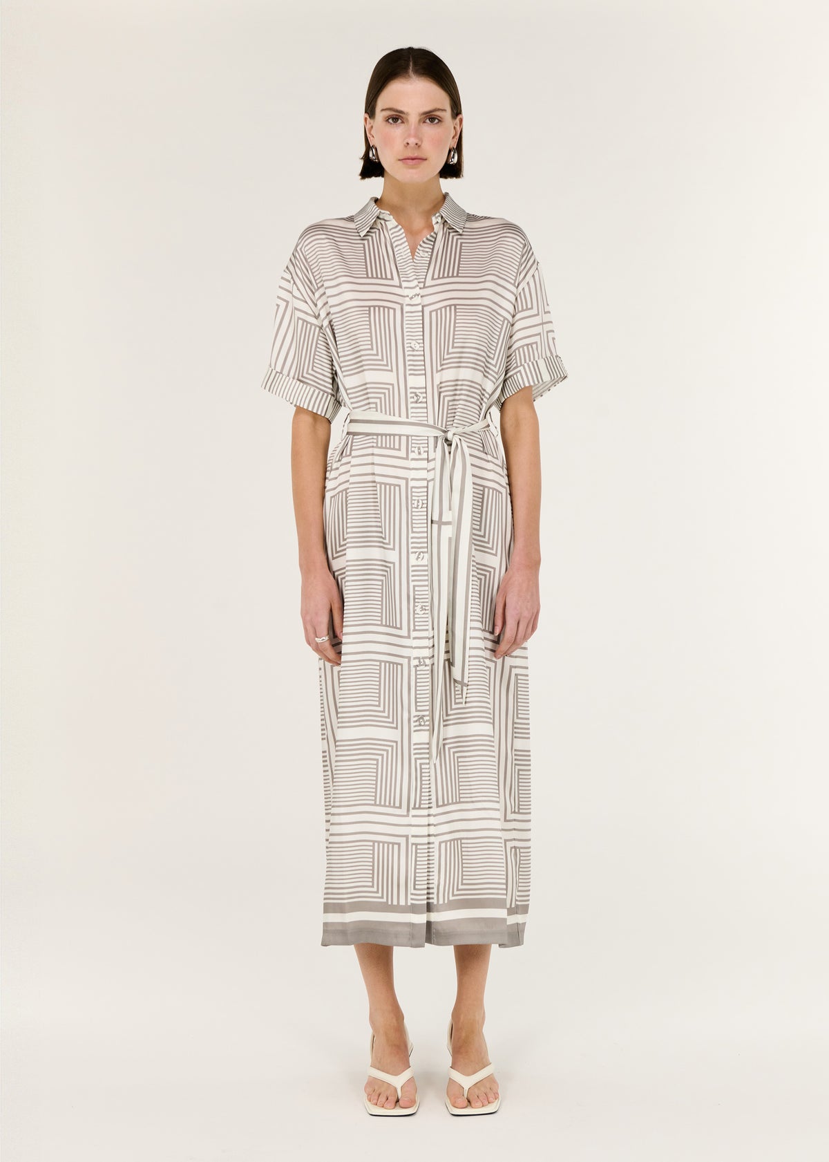 Model wearing Geometric Print Button Front Midi Shirt Dress with a midi-length shirtdress silhouette and a subtle sheen.
