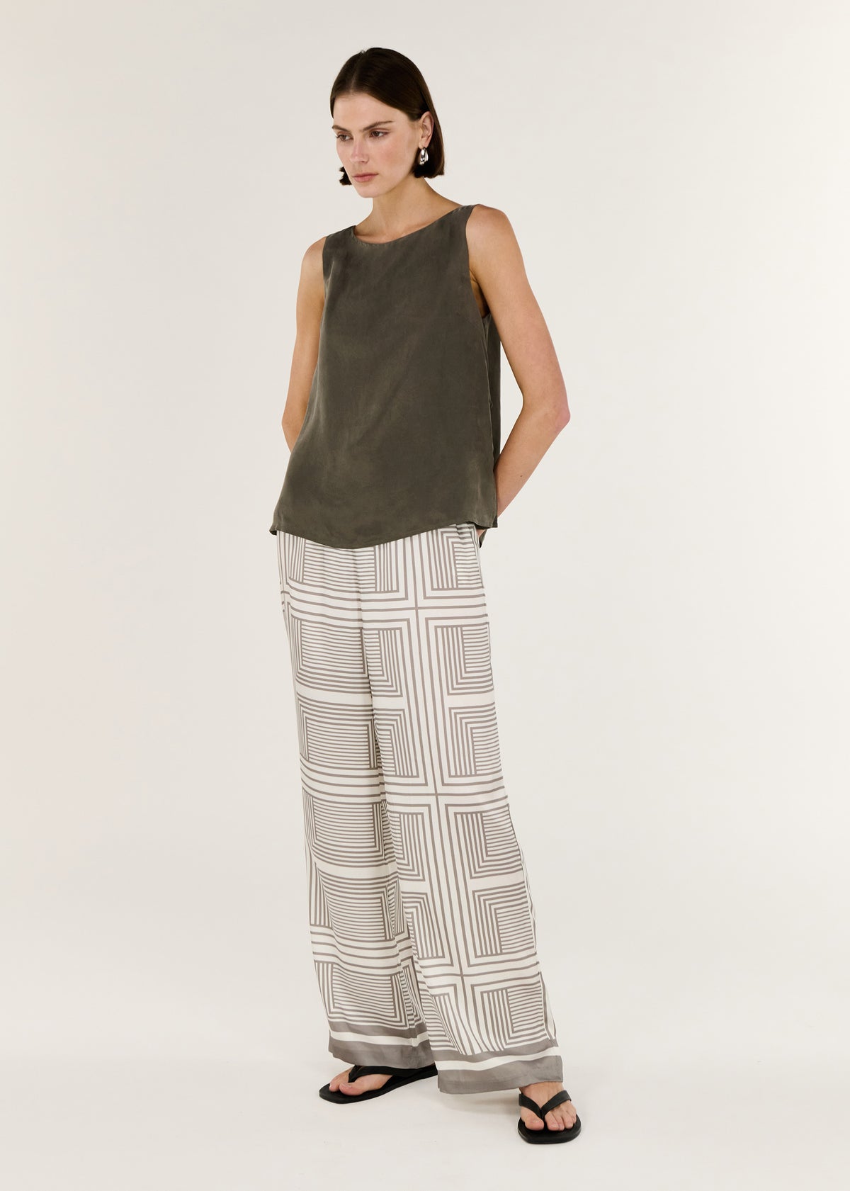 Model wearing Geometric Print Relaxed Wide-Leg Low Rise Pant, showing a graphic stripe print and a relaxed wide-leg silhouette.