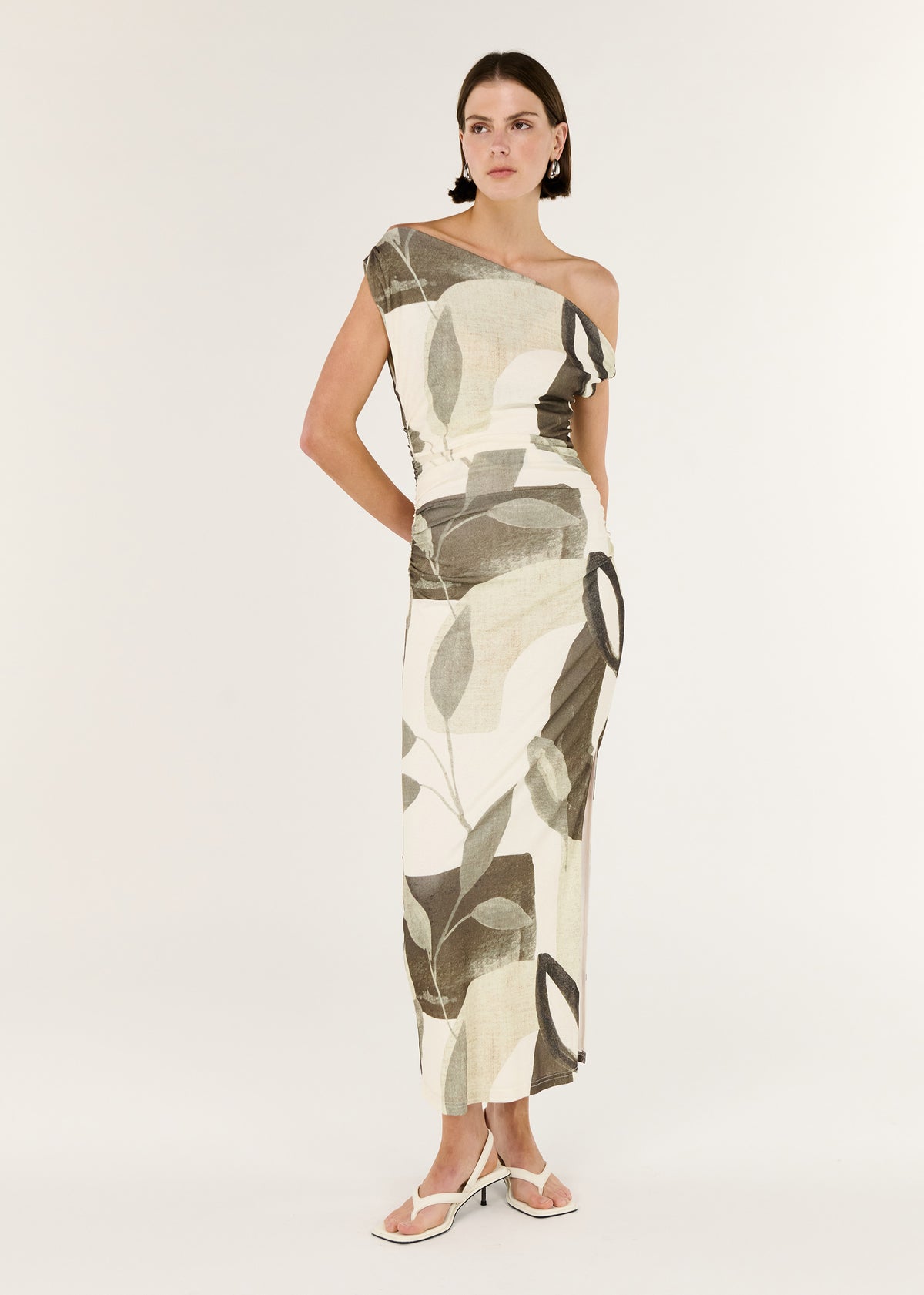 Model wearing Green Leaf Off Shoulder Midi Dress with an off-shoulder neckline and a sculptural twist detailing at shoulder.
