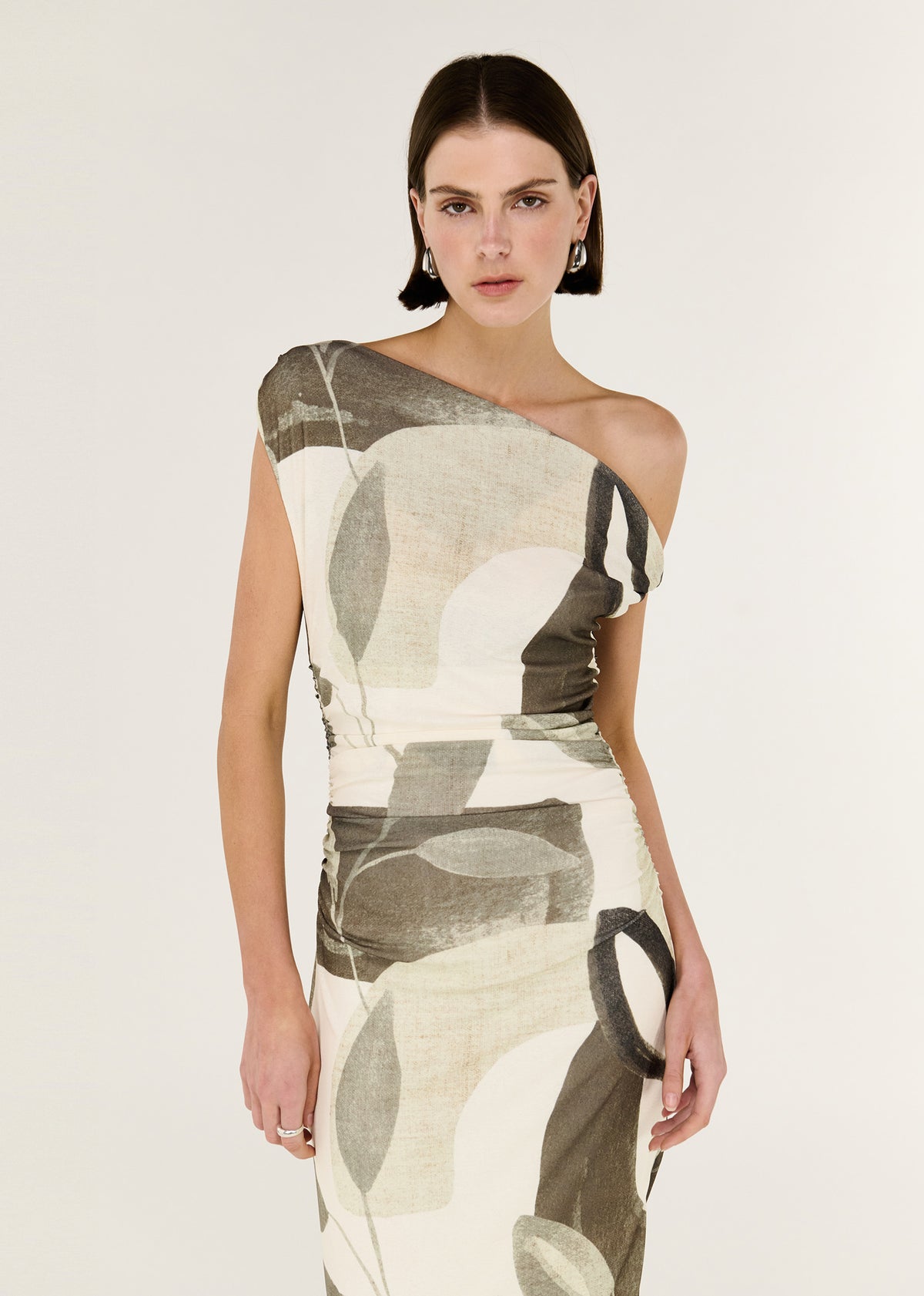 Close-up of the Green Leaf Off Shoulder Midi Dress, showing an off-shoulder neckline and a sculptural twist detailing at shoulder.