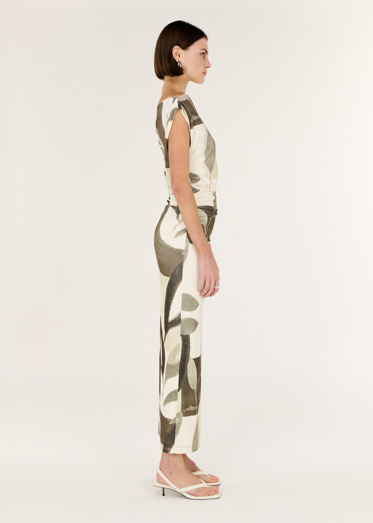 Side view of the Green Leaf Off Shoulder Midi Dress, showing a colour: Light Leaf Garden and an off-shoulder neckline.