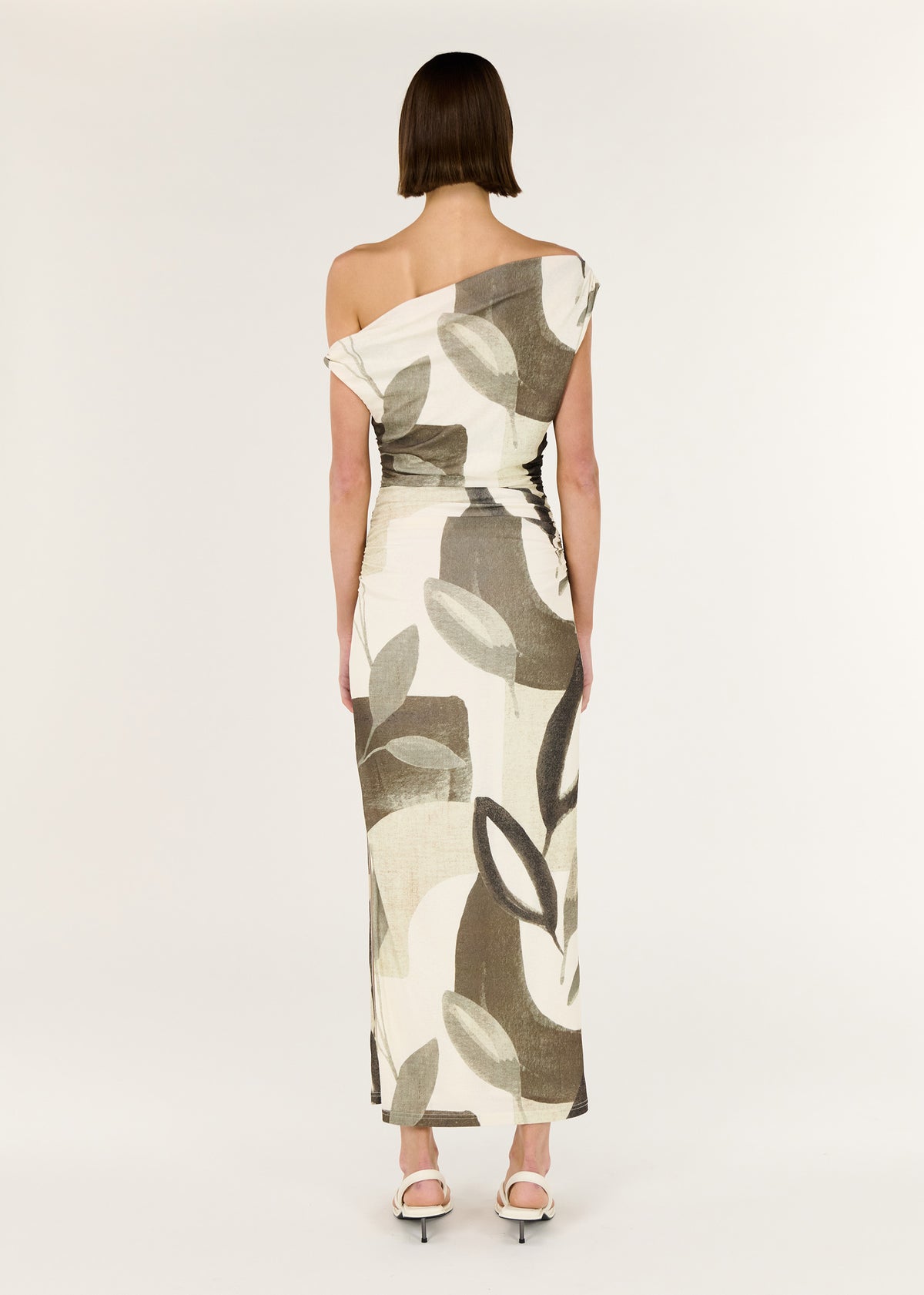 Back view of the Green Leaf Off Shoulder Midi Dress with an off-shoulder neckline and a sculptural twist detailing at shoulder.