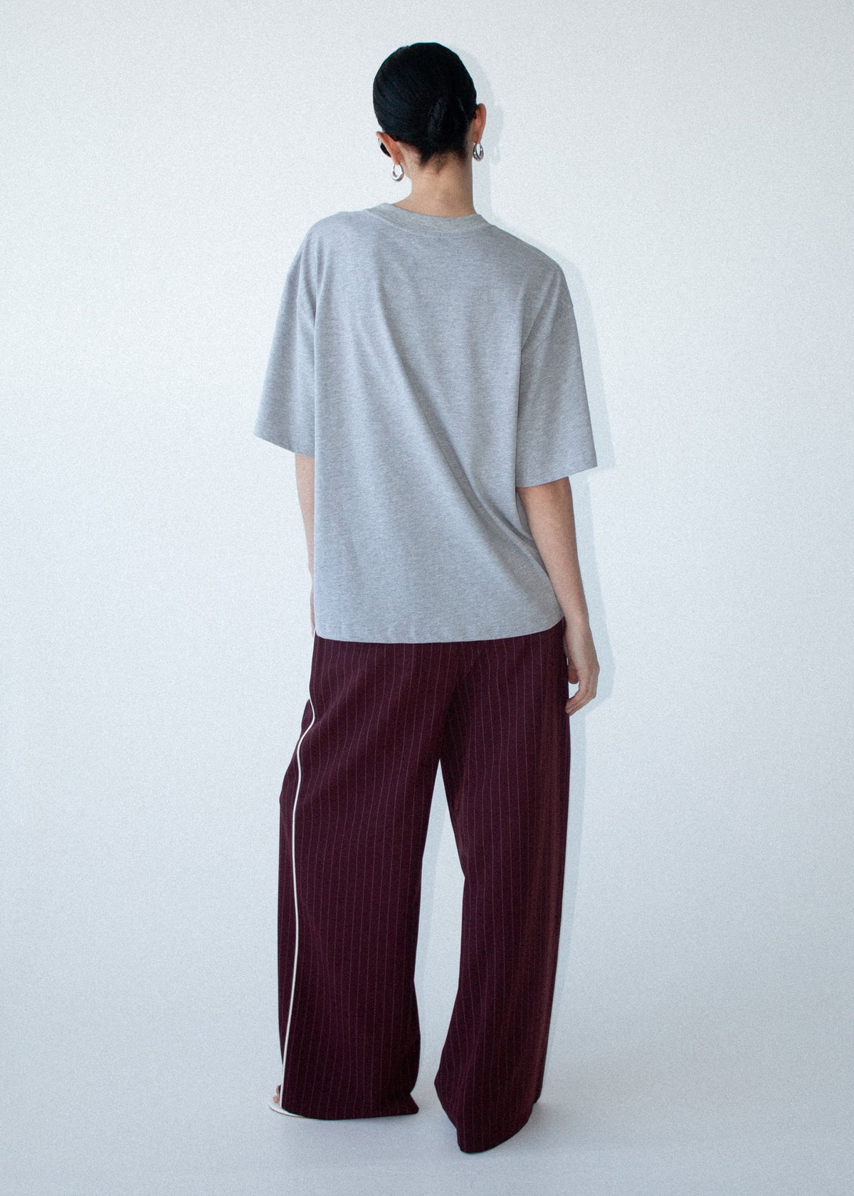 Back view of the Grey Marle Cotton Embroidered Oversized Tee with a crew neckline and an oversized fit.