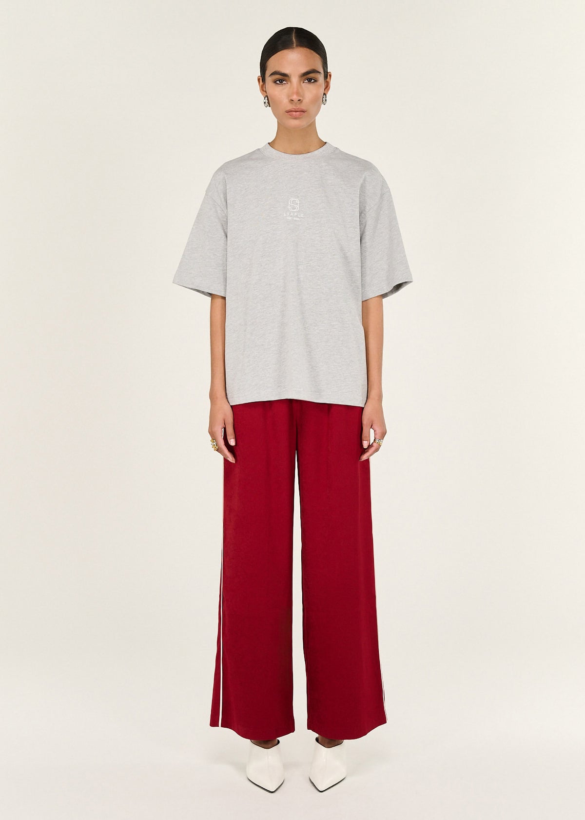 Model wearing Grey Marle Cotton Embroidered Oversized Tee, showing dropped shoulder seams and short sleeves.