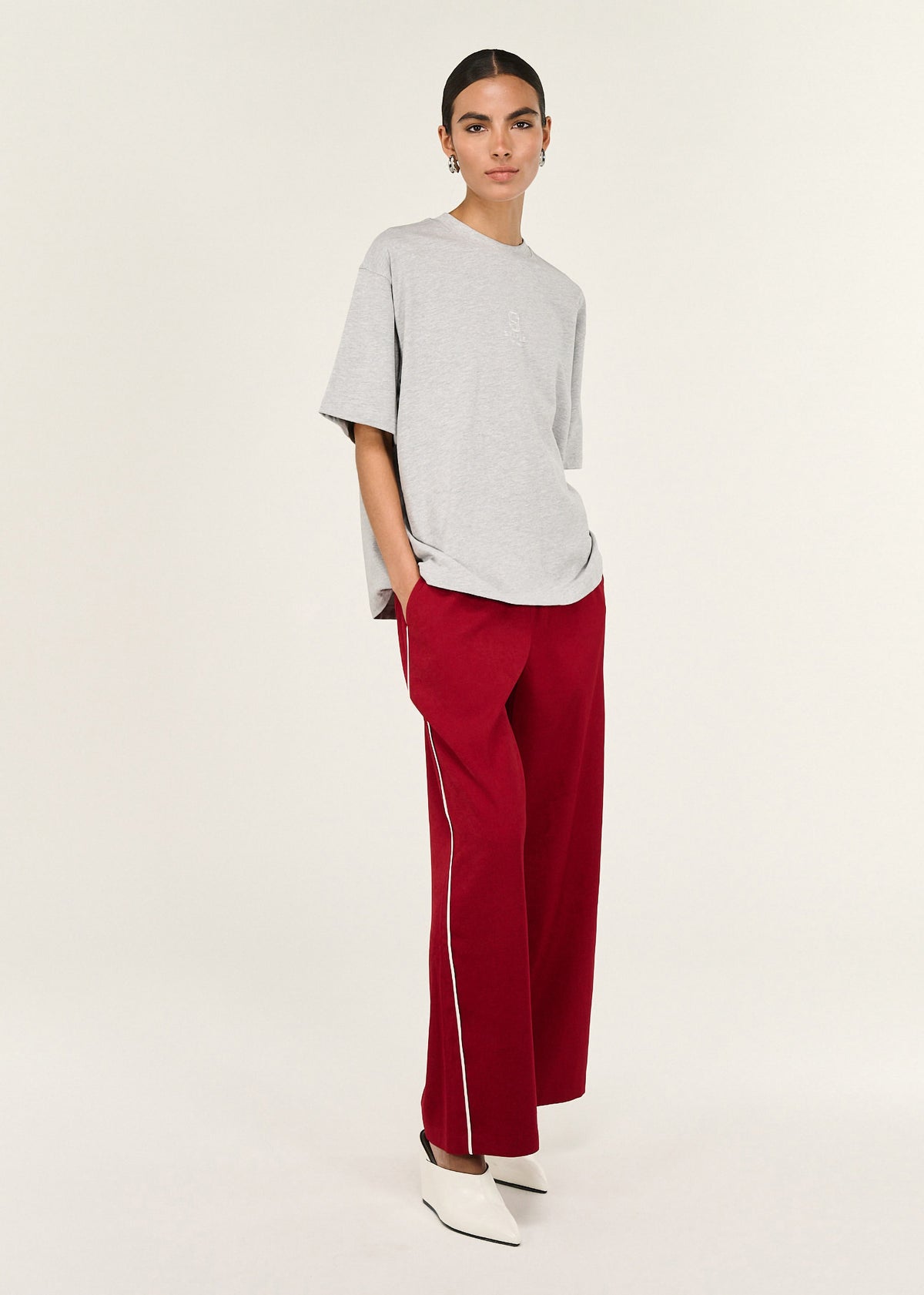 Angled view of the Grey Marle Cotton Embroidered Oversized Tee with a subtle front logo detail and a soft, breathable cotton feel.