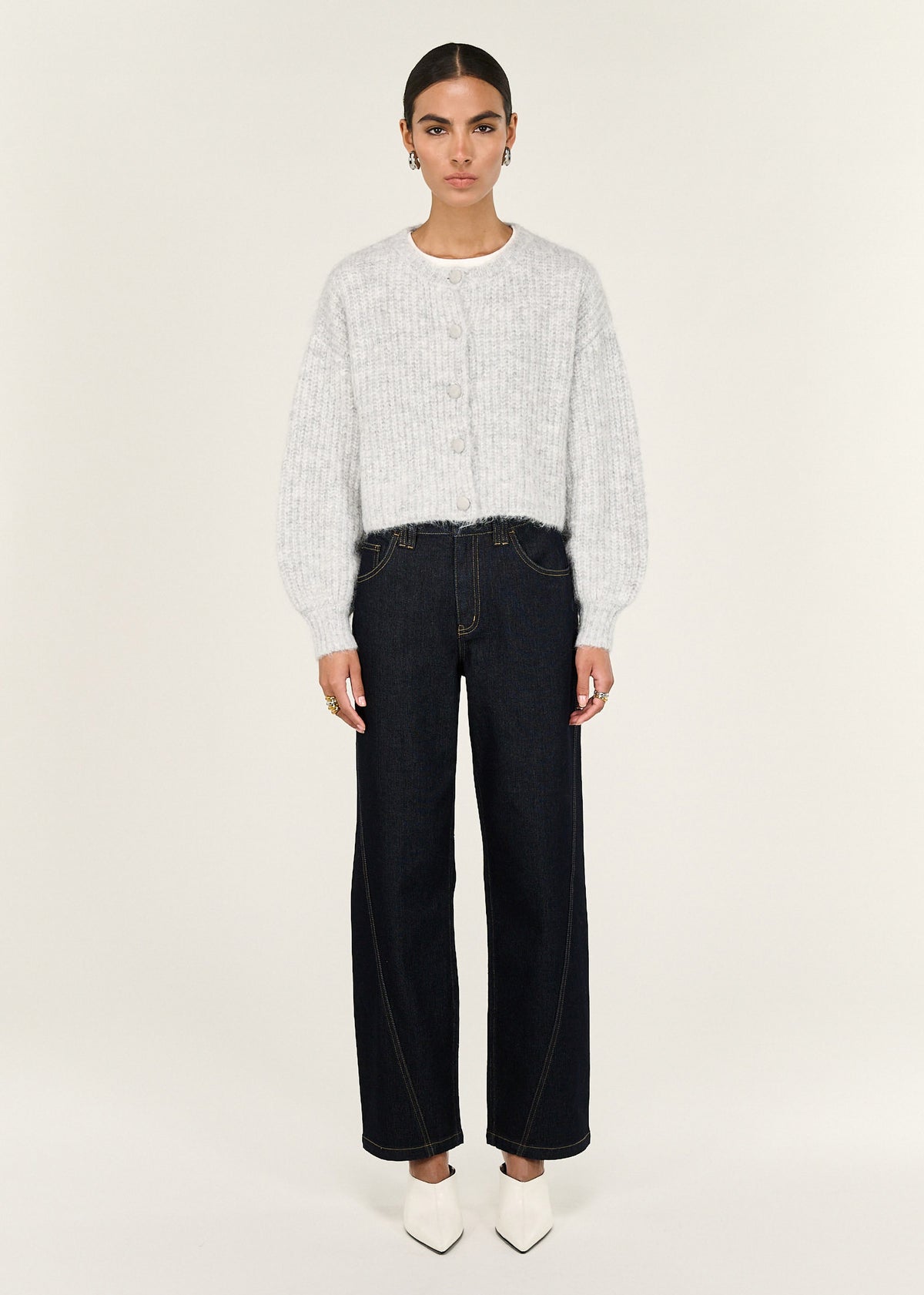 Model wearing Grey Marle Cropped Knit Cardigan with a cropped length and a textured knit fabrication.