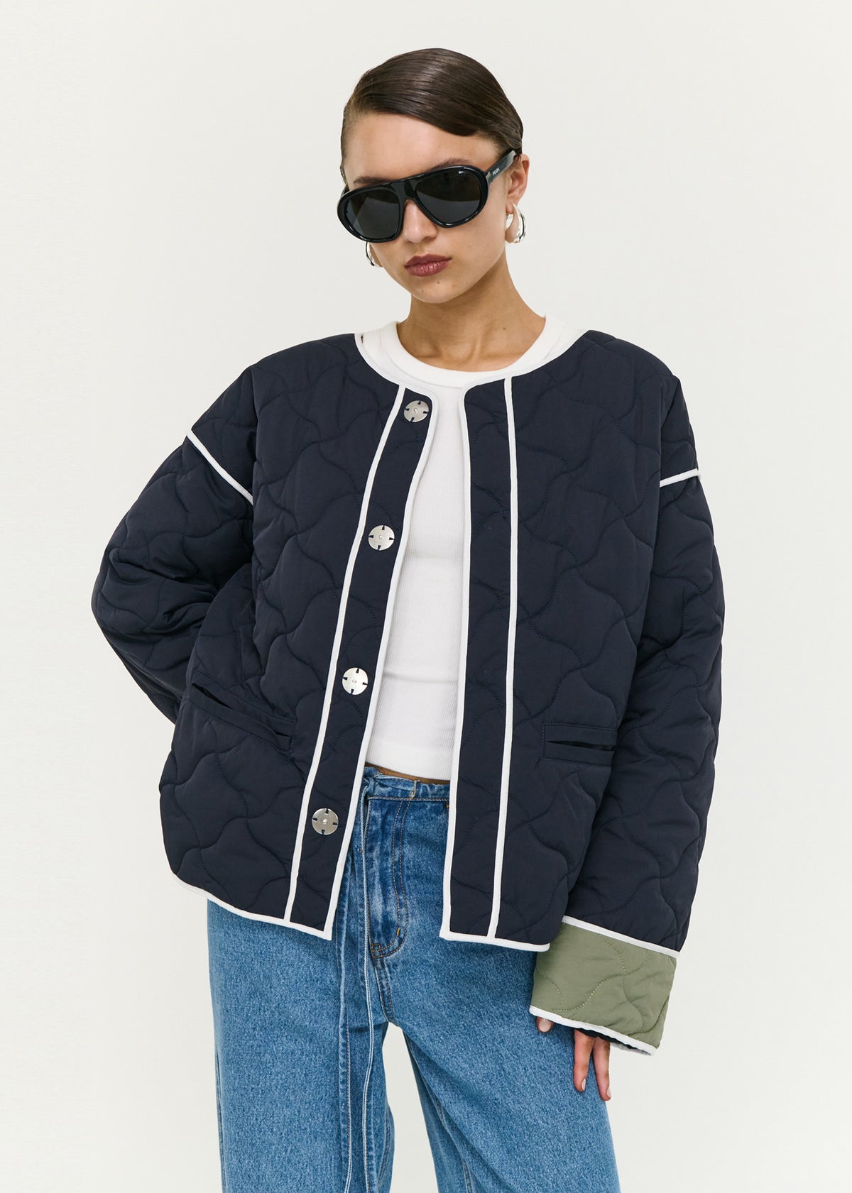 Close-up of the Hollis Puffer Jacket, showing a round neckline and an oversized snap button front closure.