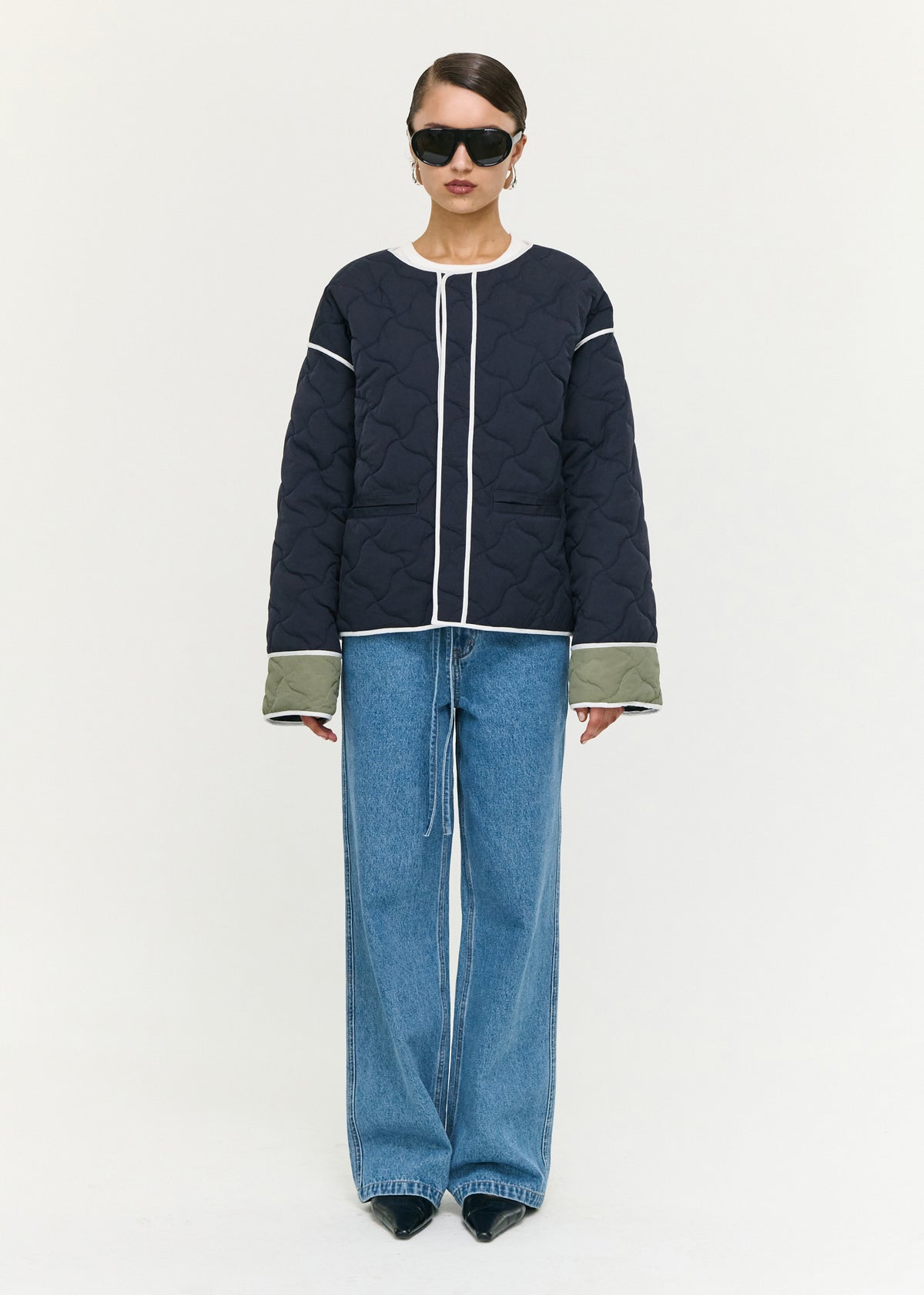 Model wearing Hollis Puffer Jacket with a round neckline and an oversized snap button front closure.