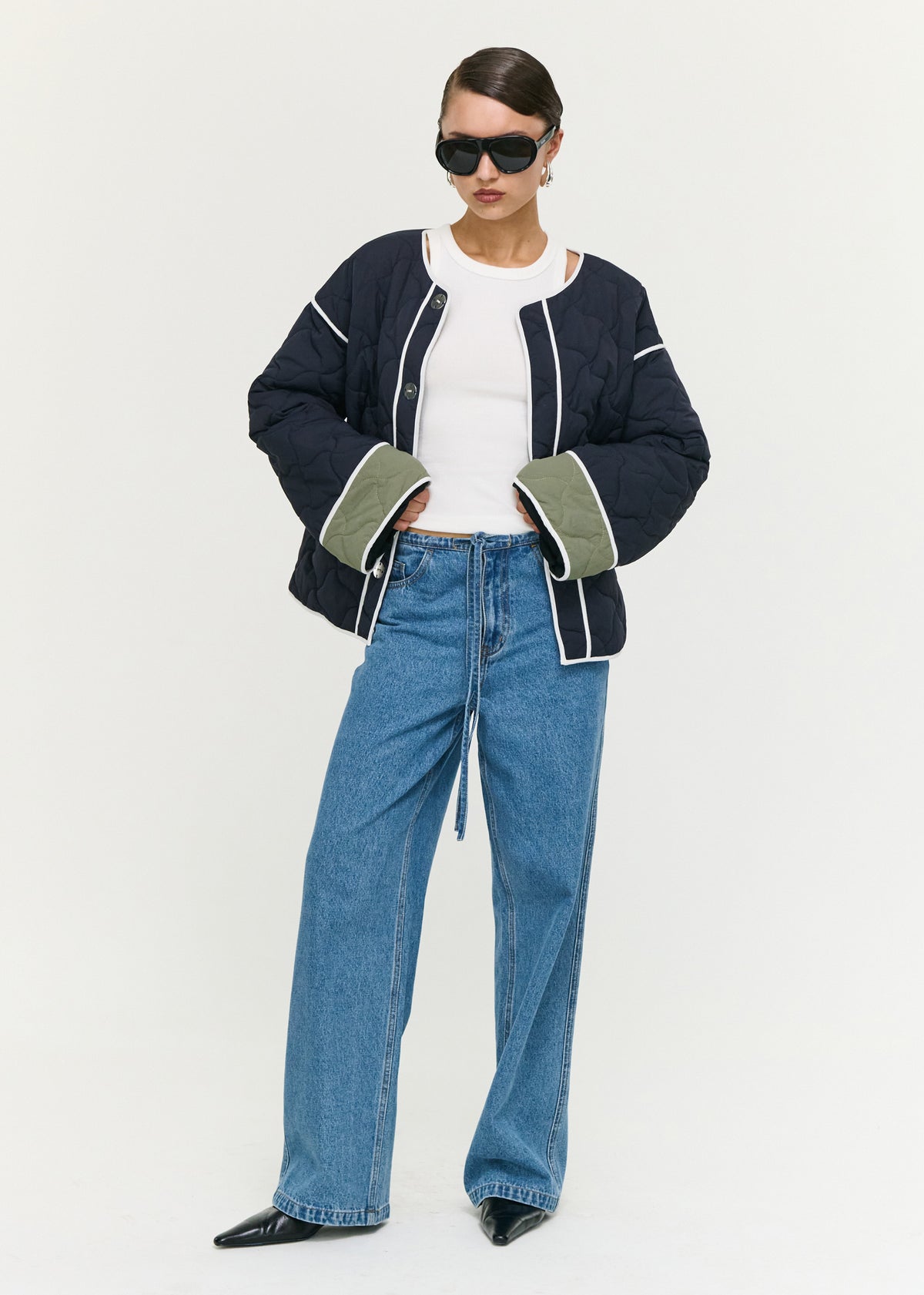 Model wearing Hollis Puffer Jacket with front welt pockets and a fully lined, turned to the side.