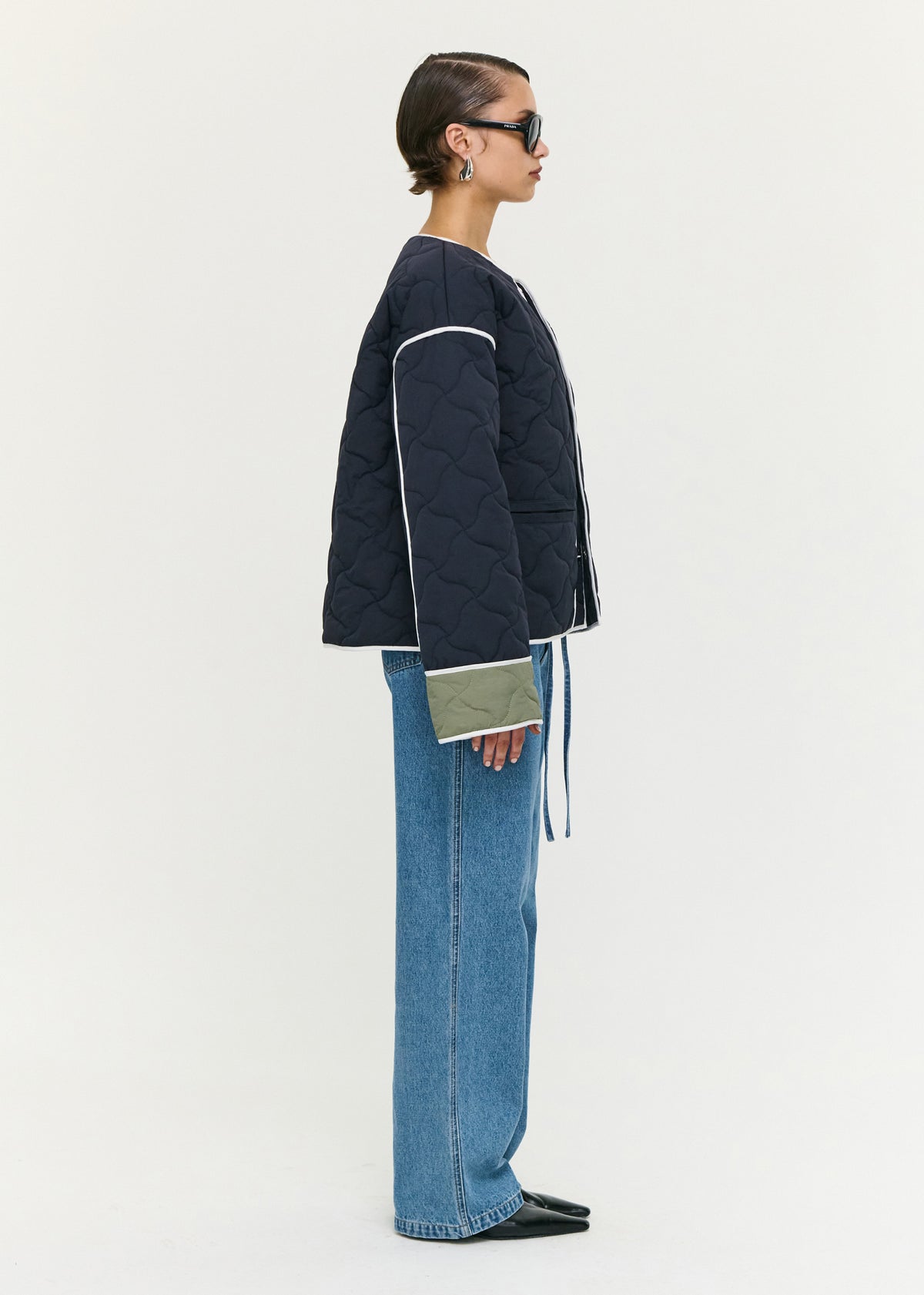 Side view of the Hollis Puffer Jacket, showing a contrast binding detailing and long sleeves with contrast cuff panels.