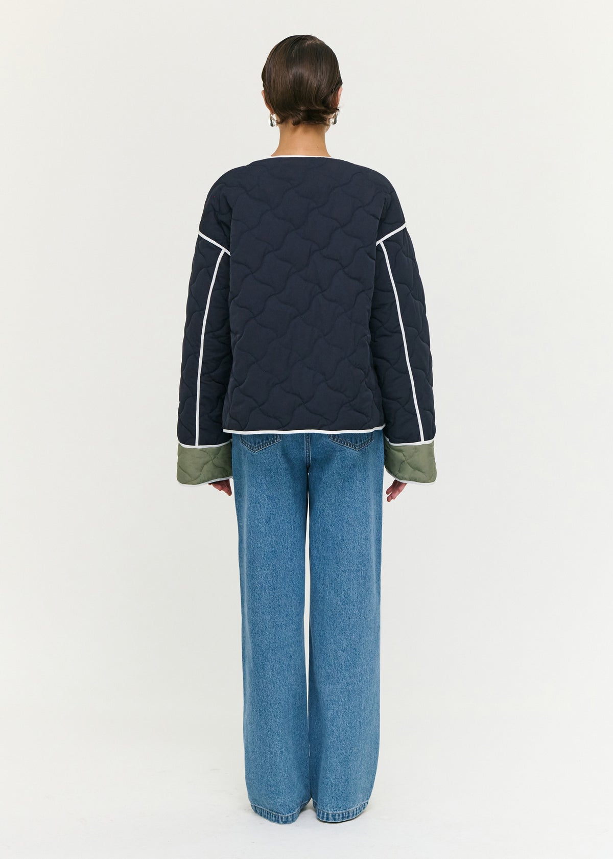 Back view of the Hollis Puffer Jacket with an oversized snap button front closure and a lightweight quilted fabrication.