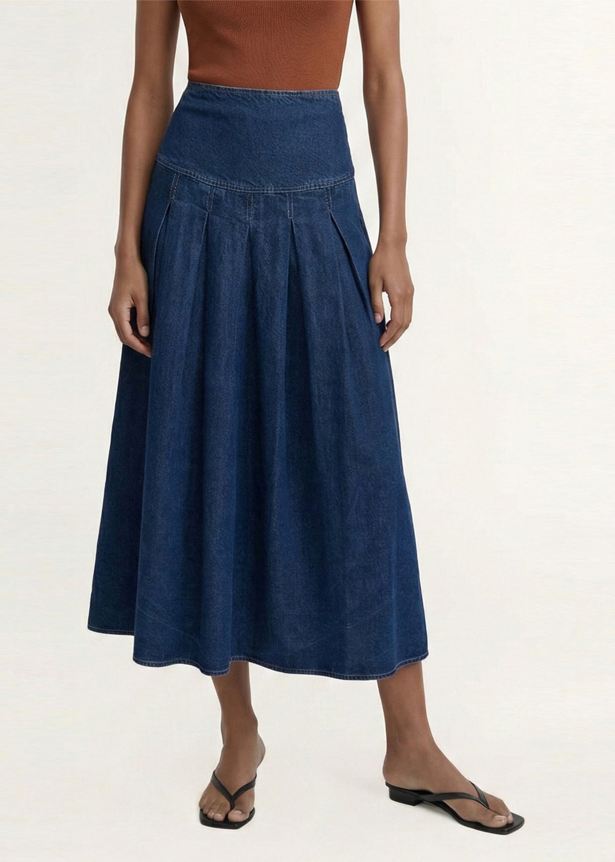 Close-up detail of the Indigo Chambray Box Pleat Midi Skirt, showing yoke and box pleats.