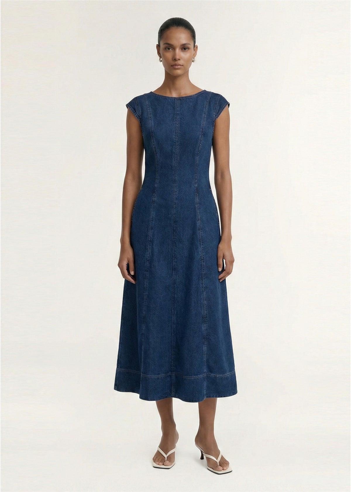 Model wearing Indigo Chambray Panelled Midi Dress with a mid-weight denim fabrication and a round neckline.