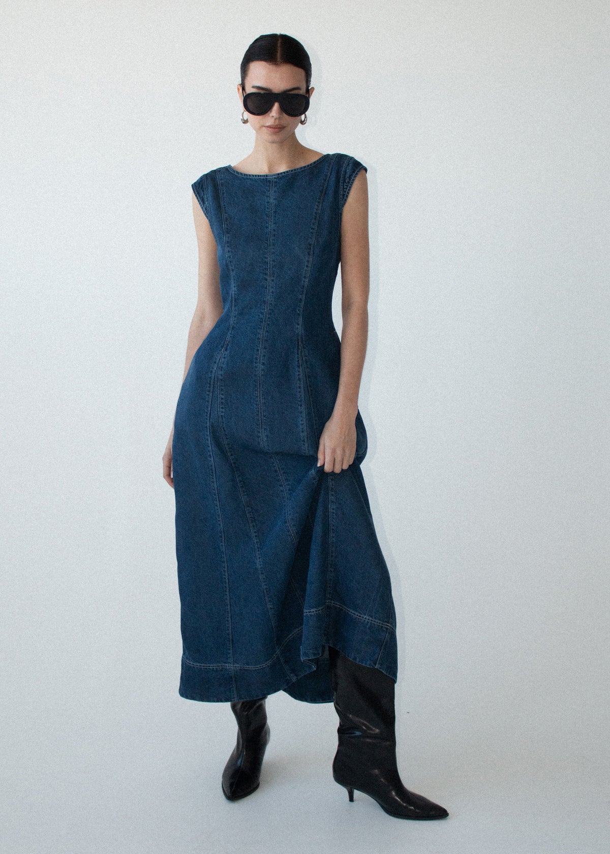 Model wearing Indigo Chambray Panelled Midi Dress, showing a fitted-and-flared silhouette and a back zip closure.