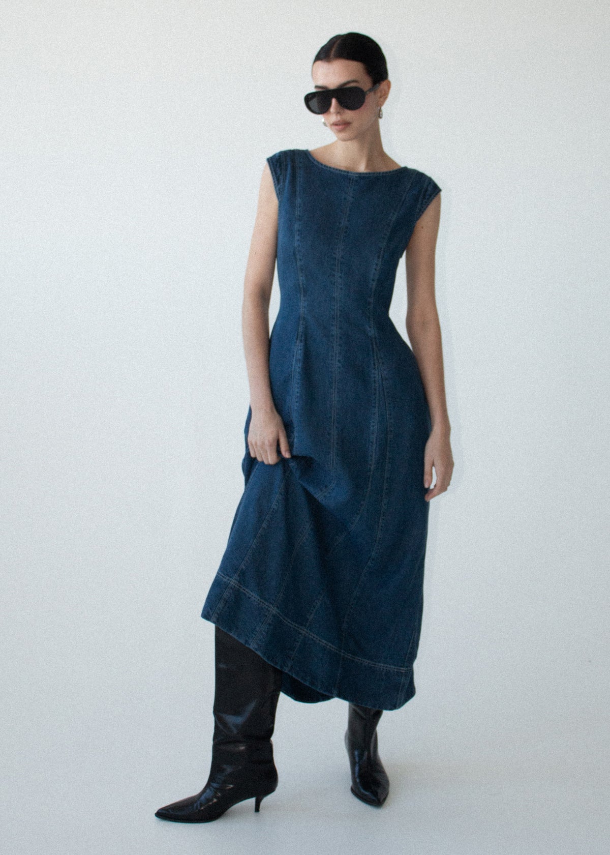 Model wearing Indigo Chambray Panelled Midi Dress with a midi length and a mid-weight denim fabrication.