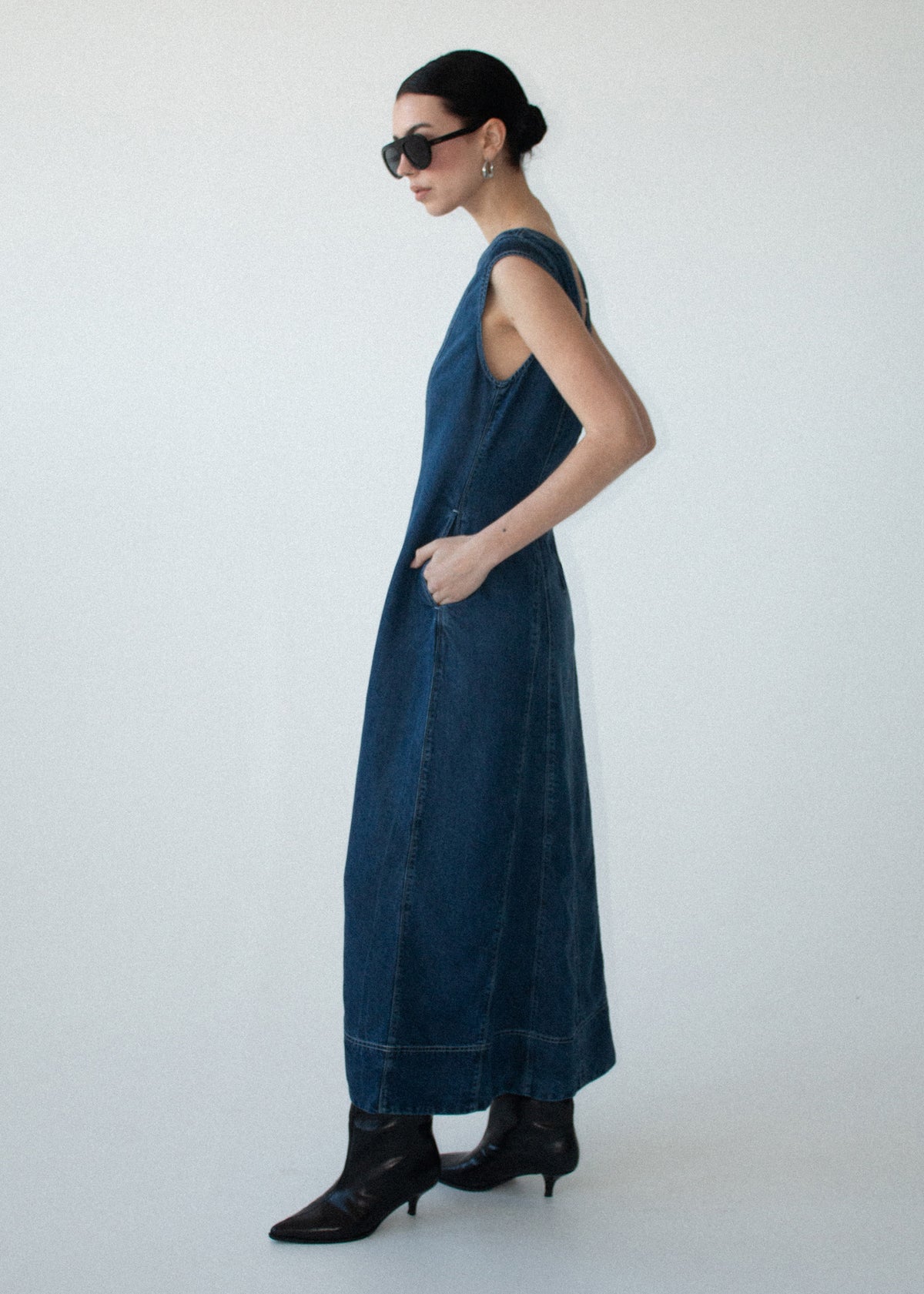 Side view of the Indigo Chambray Panelled Midi Dress, showing a round neckline and cap sleeves.