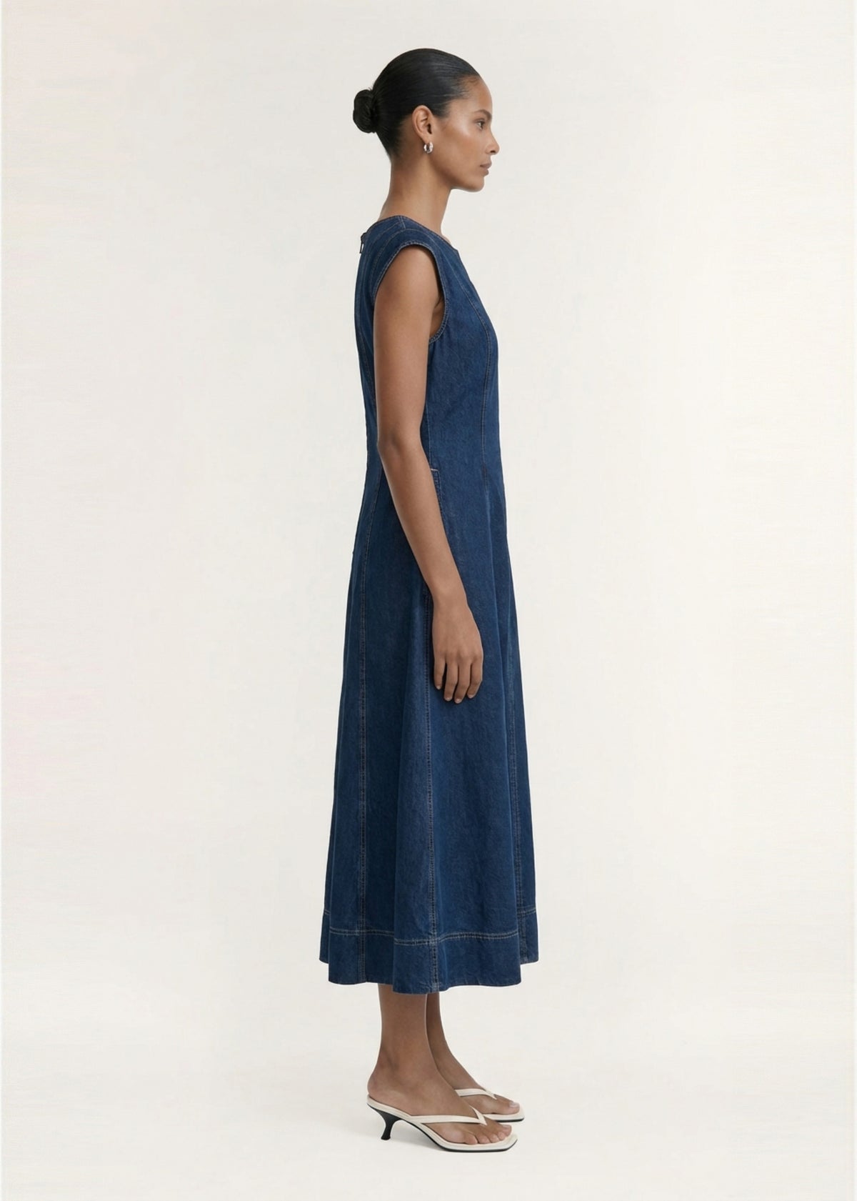 Side profile of the Indigo Chambray Panelled Midi Dress with a back zip closure and a midi length.