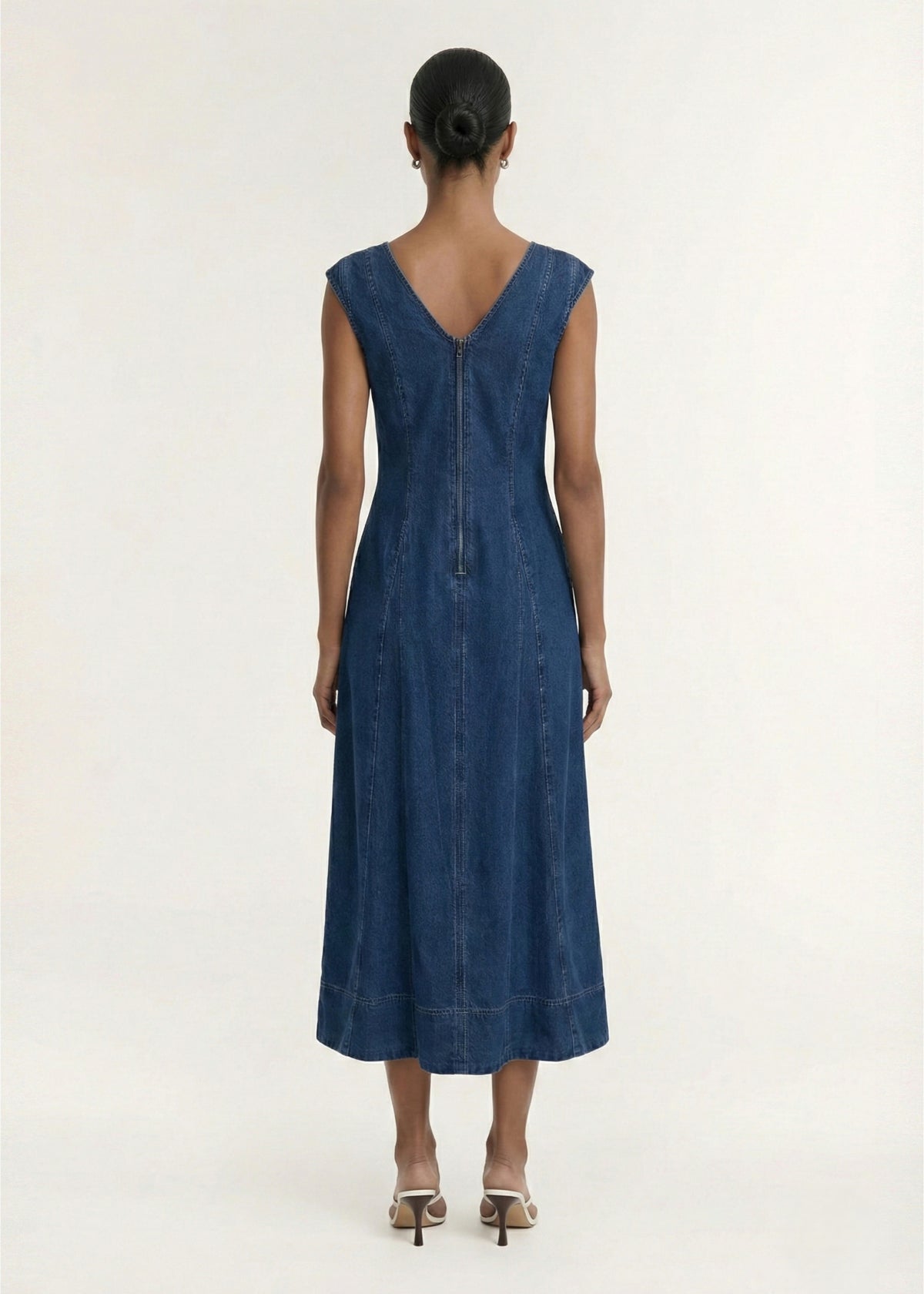 Back view of the Indigo Chambray Panelled Midi Dress, showing a back zip closure and a mid-weight denim fabrication.