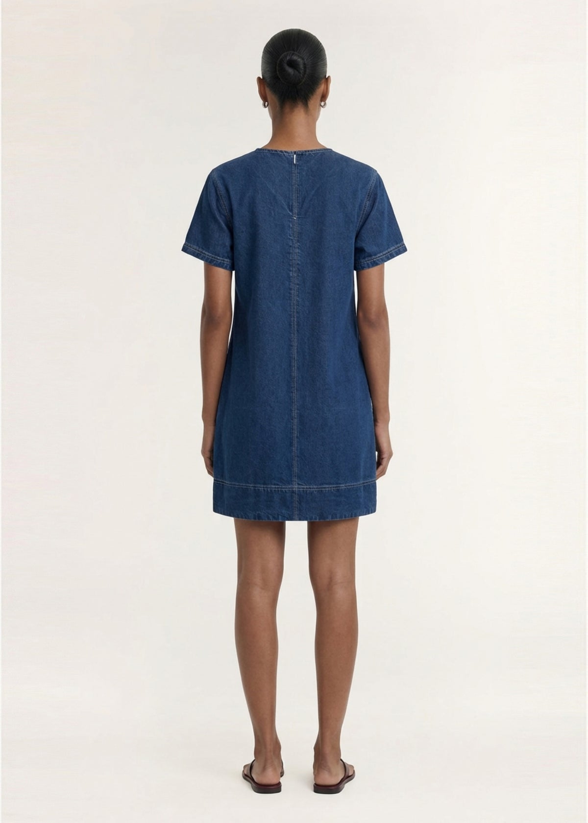 Back view of the Indigo Chambray Short Sleeve Mini Dress, showing a back zip closure and a mid-weight denim fabrication.