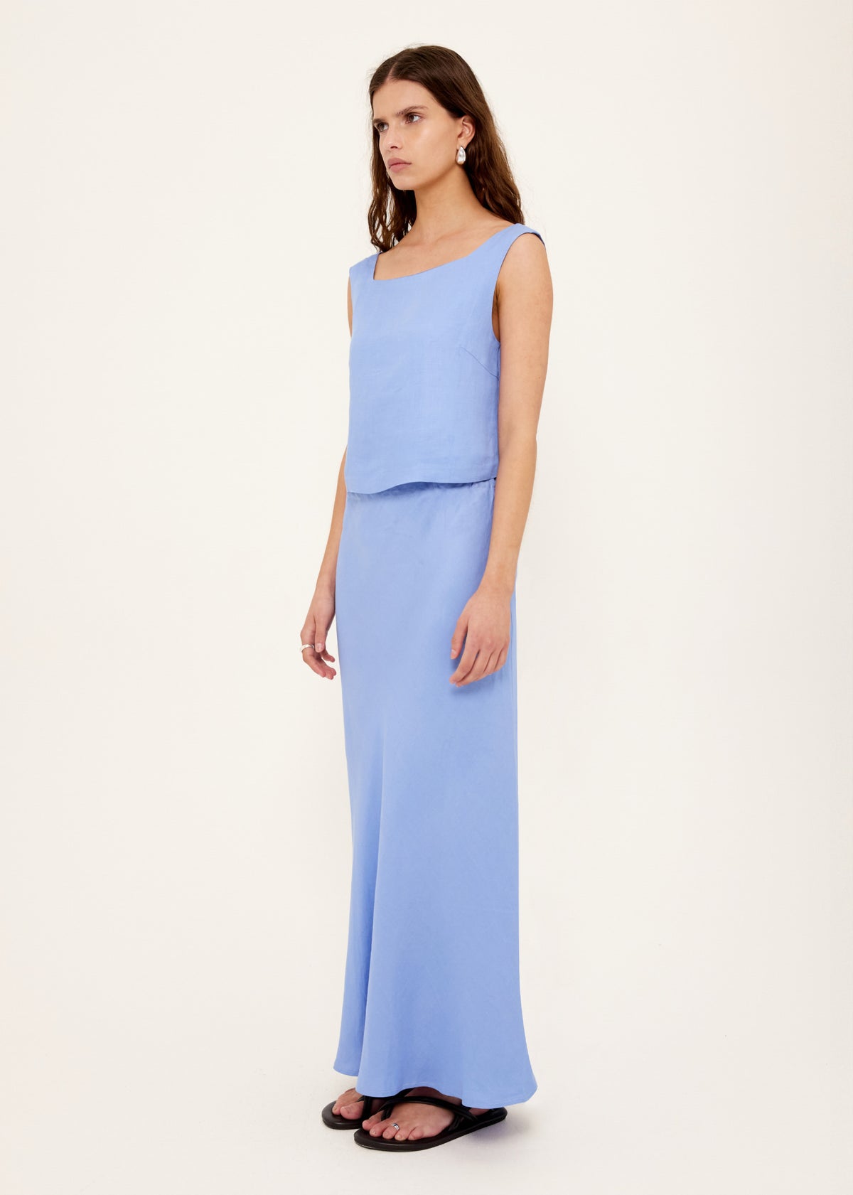 Model wearing Jacaranda Tencel Linen Blend Maxi Skirt, showing a textured linen-blend fabrication and a bias-cut silhouette.