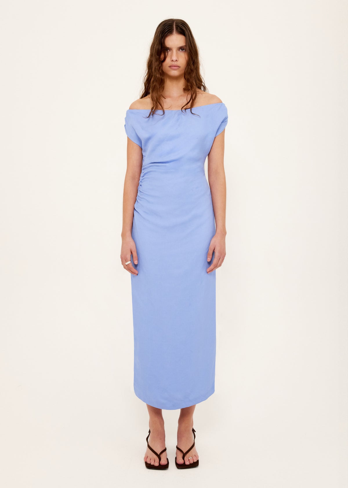 Model wearing Jacaranda Tencel Linen Blend Off-Shoulder Midi Dress with an off-shoulder neckline with draped detailing and a side ruching.