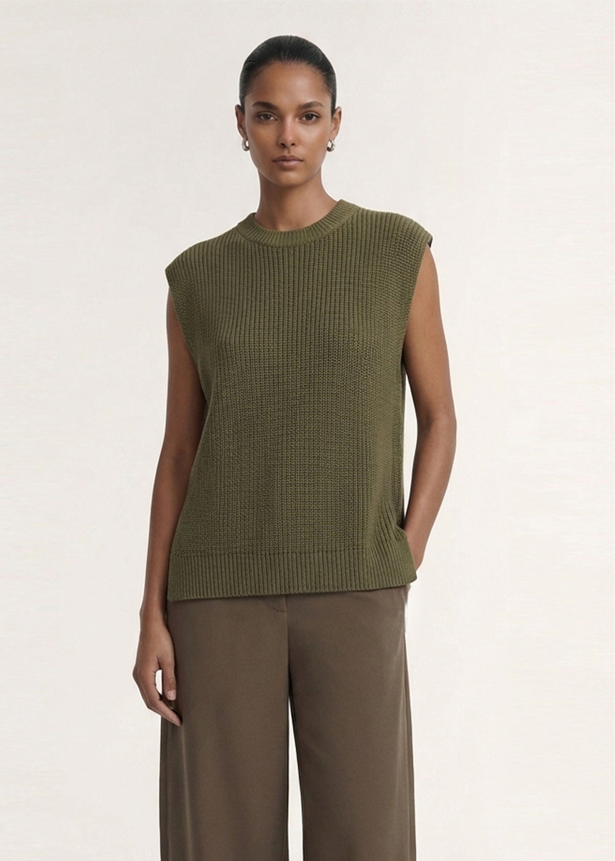 Model wearing Khaki Cotton Blend Knit Tank Top with a textured rib knit fabrication and a sleeveless silhouette.