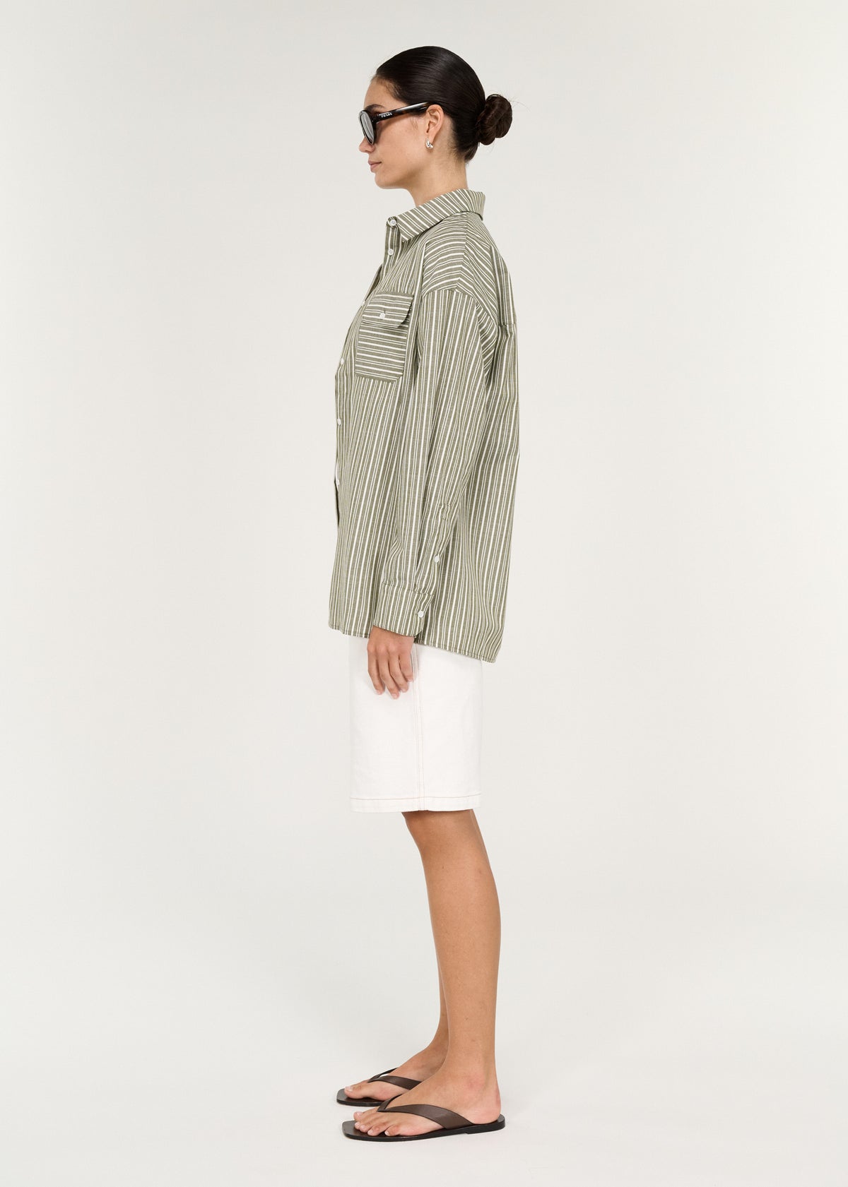 Side view of the Khaki Stripe Cotton Oversized Shirt, showing a chest patch pocket with button detail and a curved hemline.
