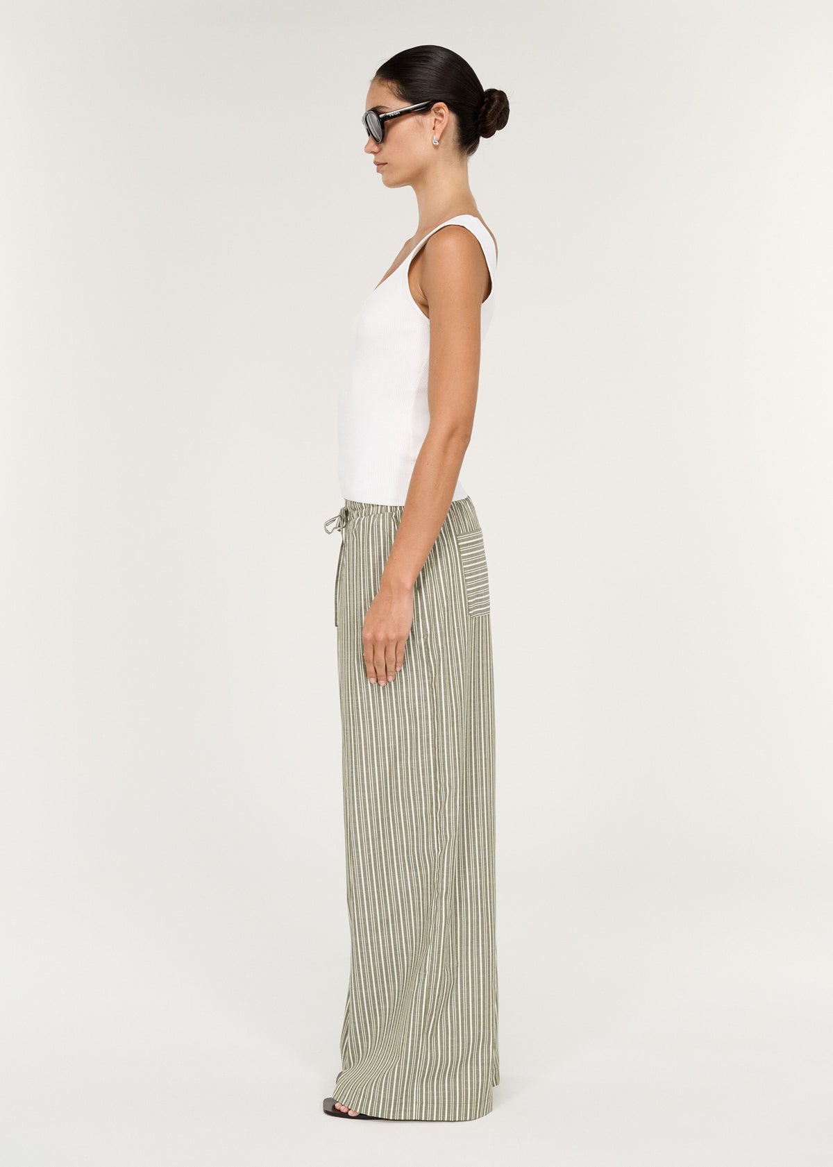 Side view of the Khaki Stripe Relaxed Cotton Pant, showing a relaxed wide-leg silhouette and a full length.