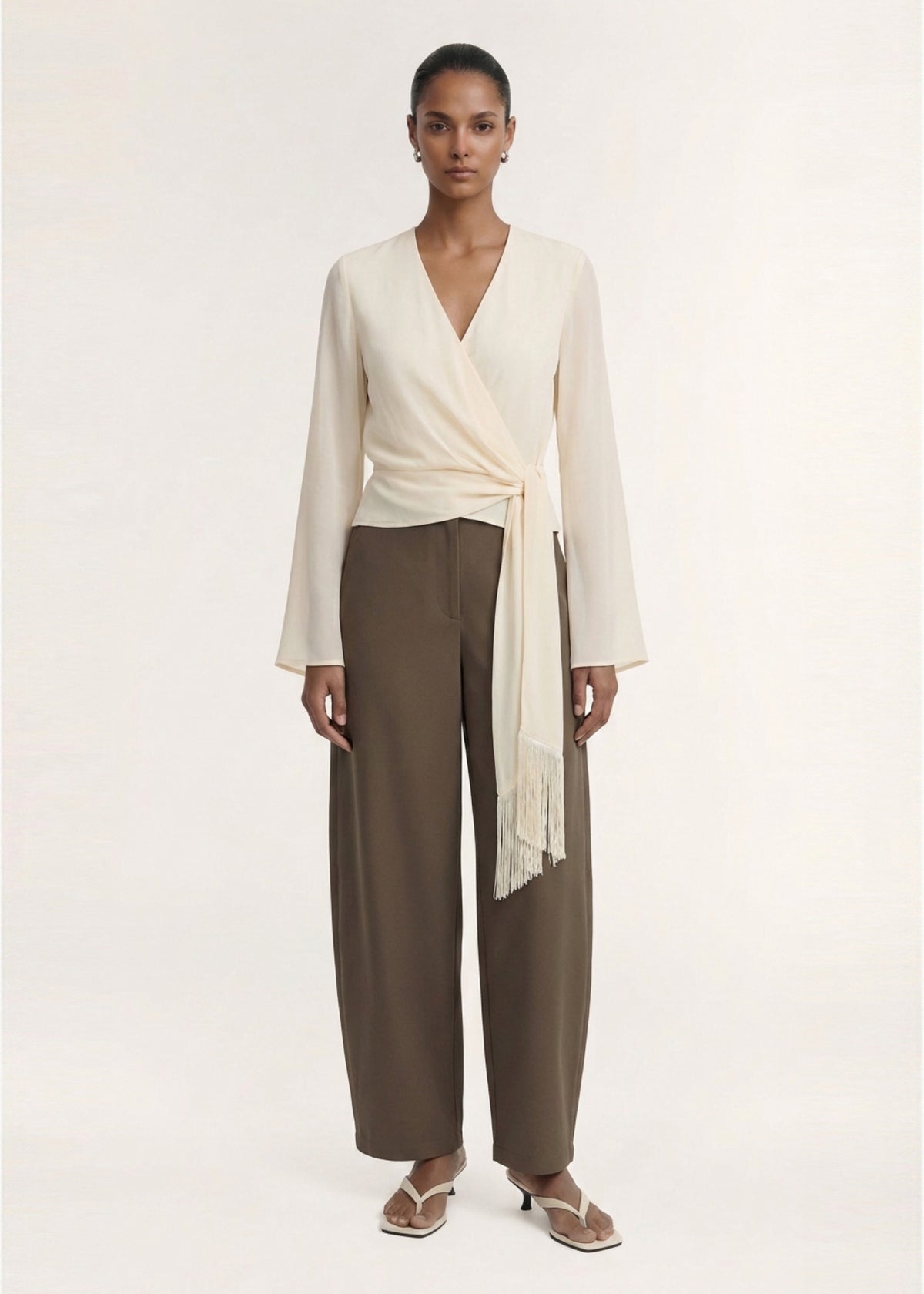 Model wearing Khaki Structured Barrel Leg Pant with a soft woven fabrication and a barrel leg silhouette.