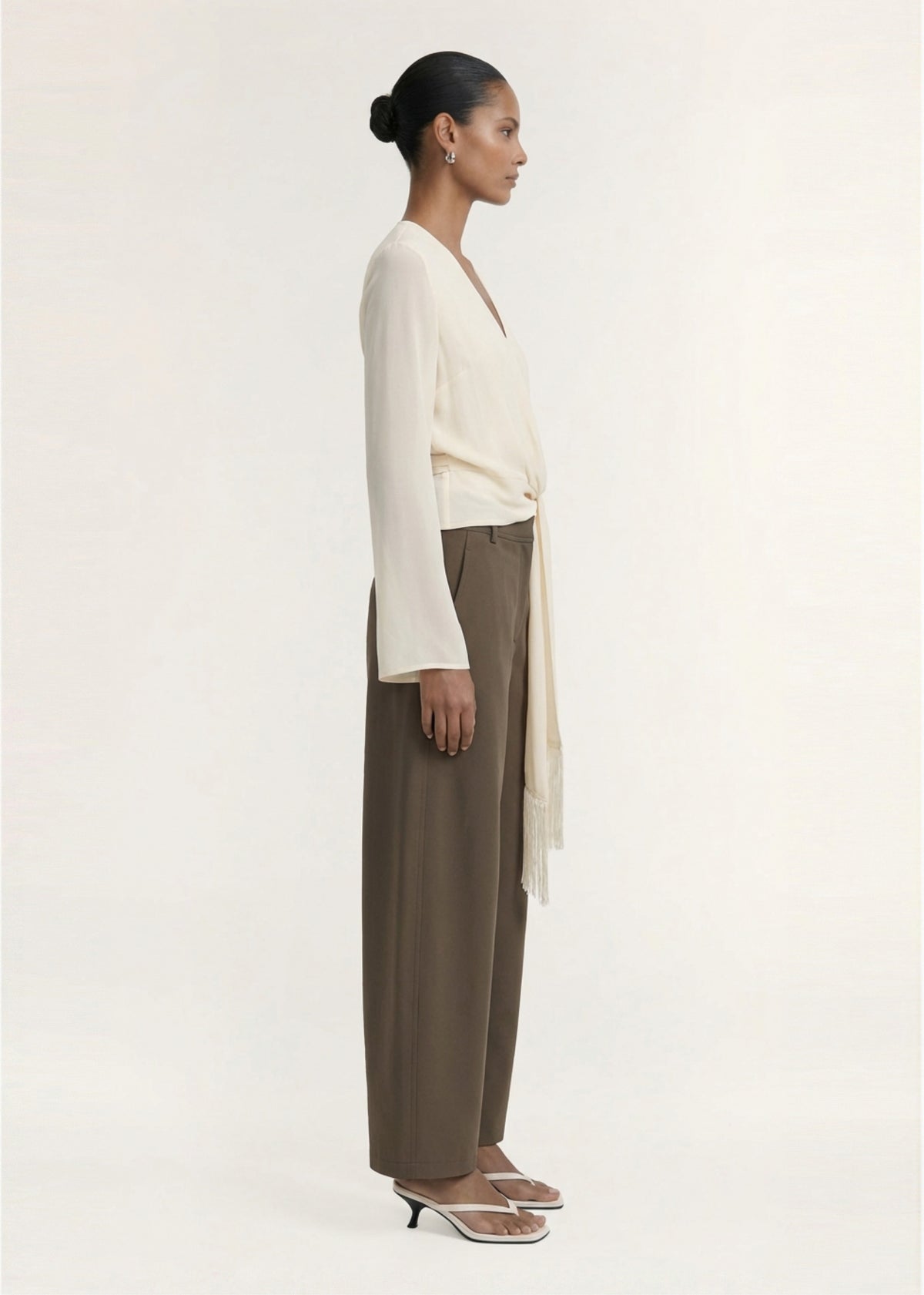 Side profile of the Khaki Structured Barrel Leg Pant with a barrel leg silhouette and a relaxed fit through the leg.