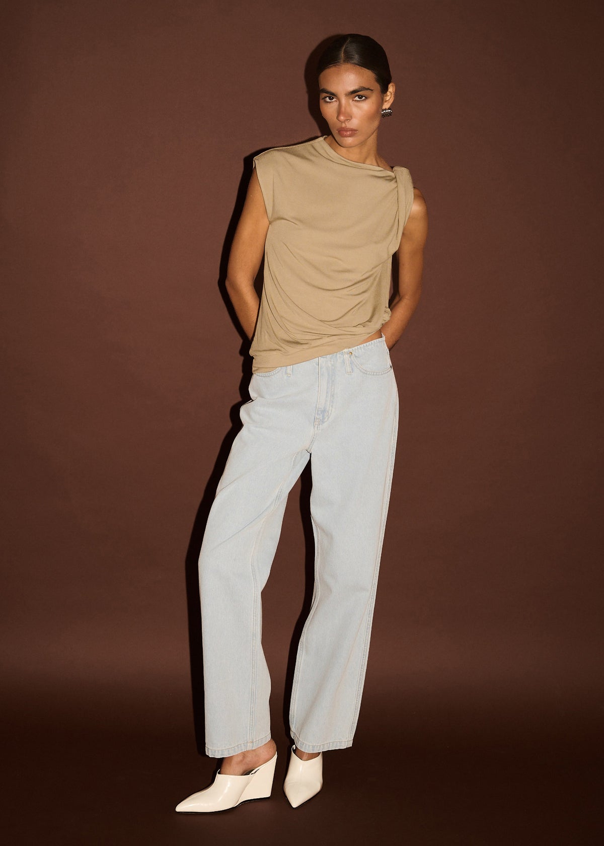 Model wearing Light Wash Straight Leg Denim Jeans with a light wash denim finish and a slight comfort stretch, turned to the side.