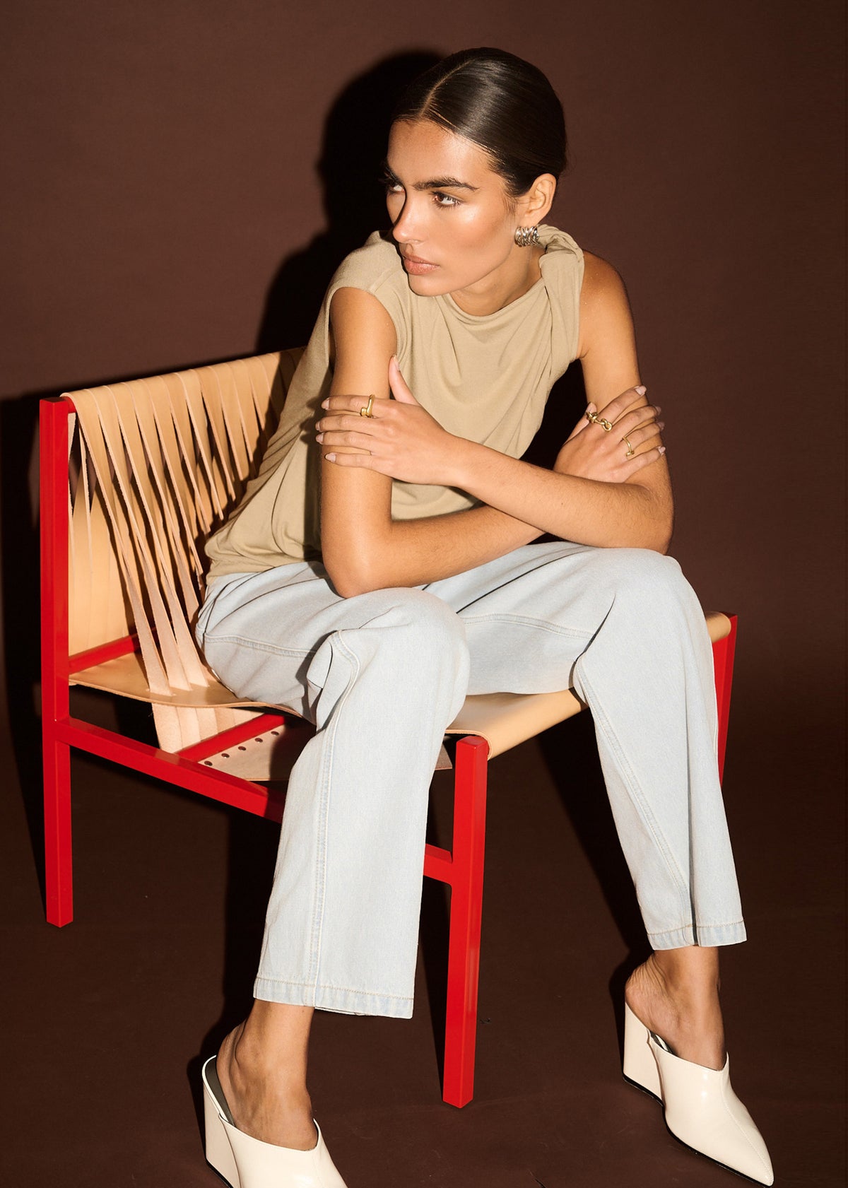 Model seated wearing Light Wash Straight Leg Denim Jeans with a high-rise waist and a straight leg silhouette.