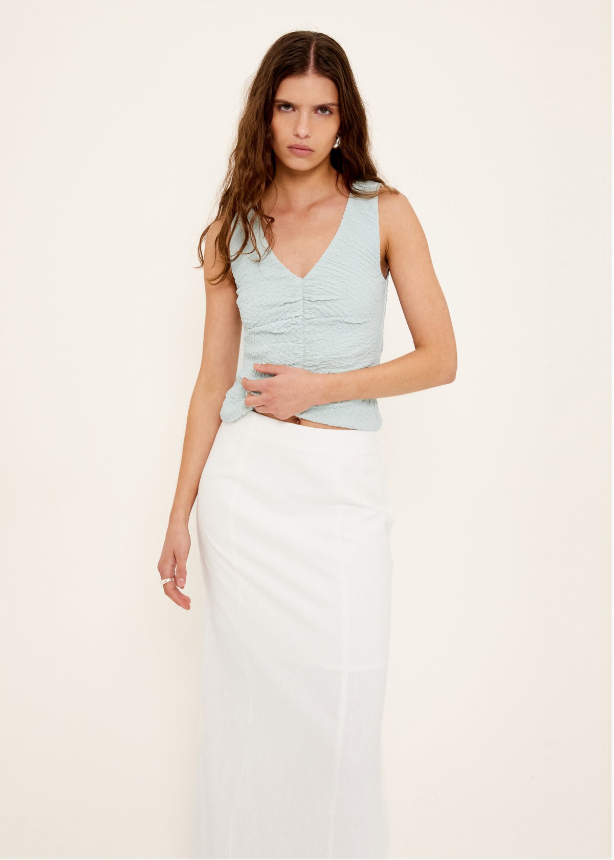 Close-up of the Linen Cotton Blend White Midi Skirt, showing a high-waisted, straight cut midi silhouette and a side split.