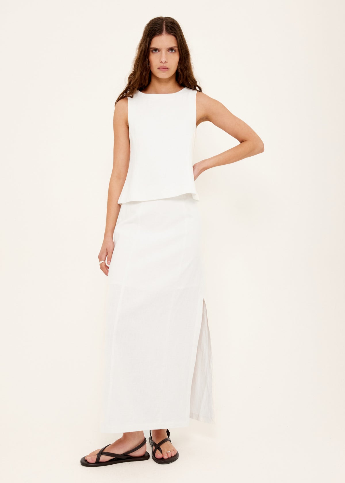 Model wearing Linen Cotton Blend White Midi Skirt, showing a crafted from a breathable linen-cotton blend and a fully lined.