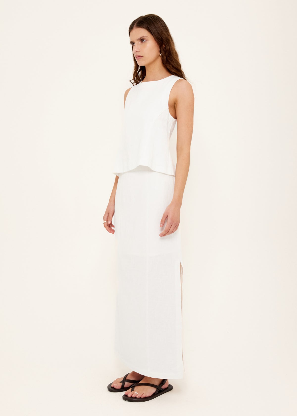 Model wearing Linen Cotton Blend White Midi Skirt with an invisible zip closure at side and a fully lined.
