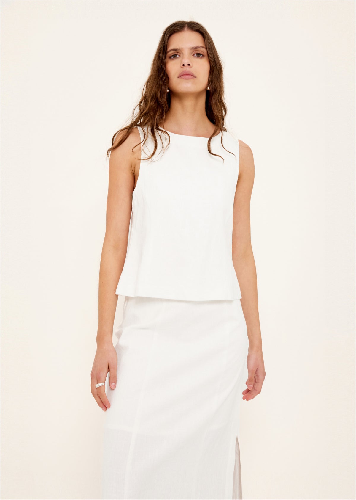 Close-up of the Linen Cotton Blend White Top, showing a sleeveless, structured silhouette.