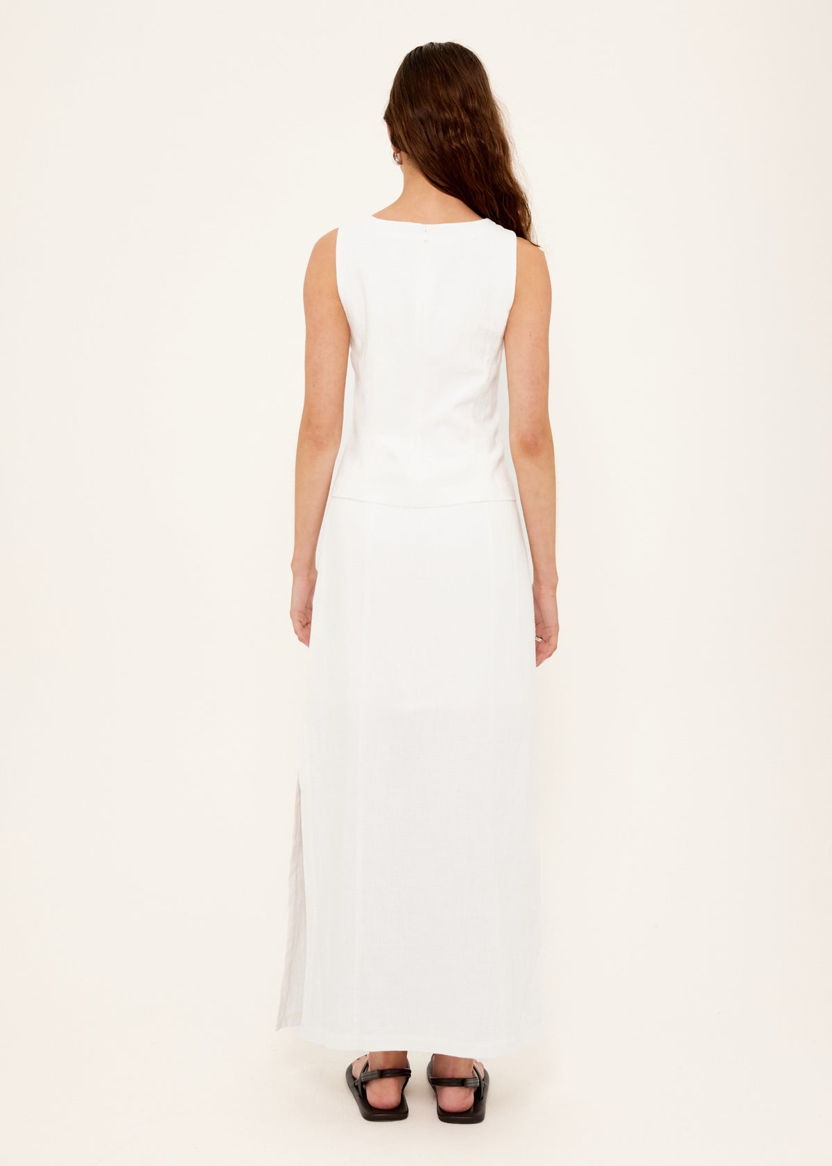 Back view of the Linen Cotton Blend White Top with a concealed zip closure at back and a sleeveless, structured silhouette.