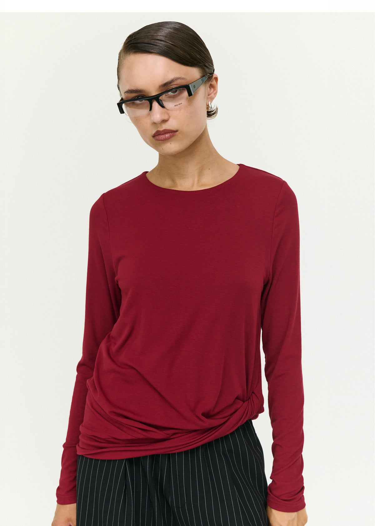 Close-up of the Long Sleeve Jersey Twist Top in Merlot, showing a round neckline and long sleeves.