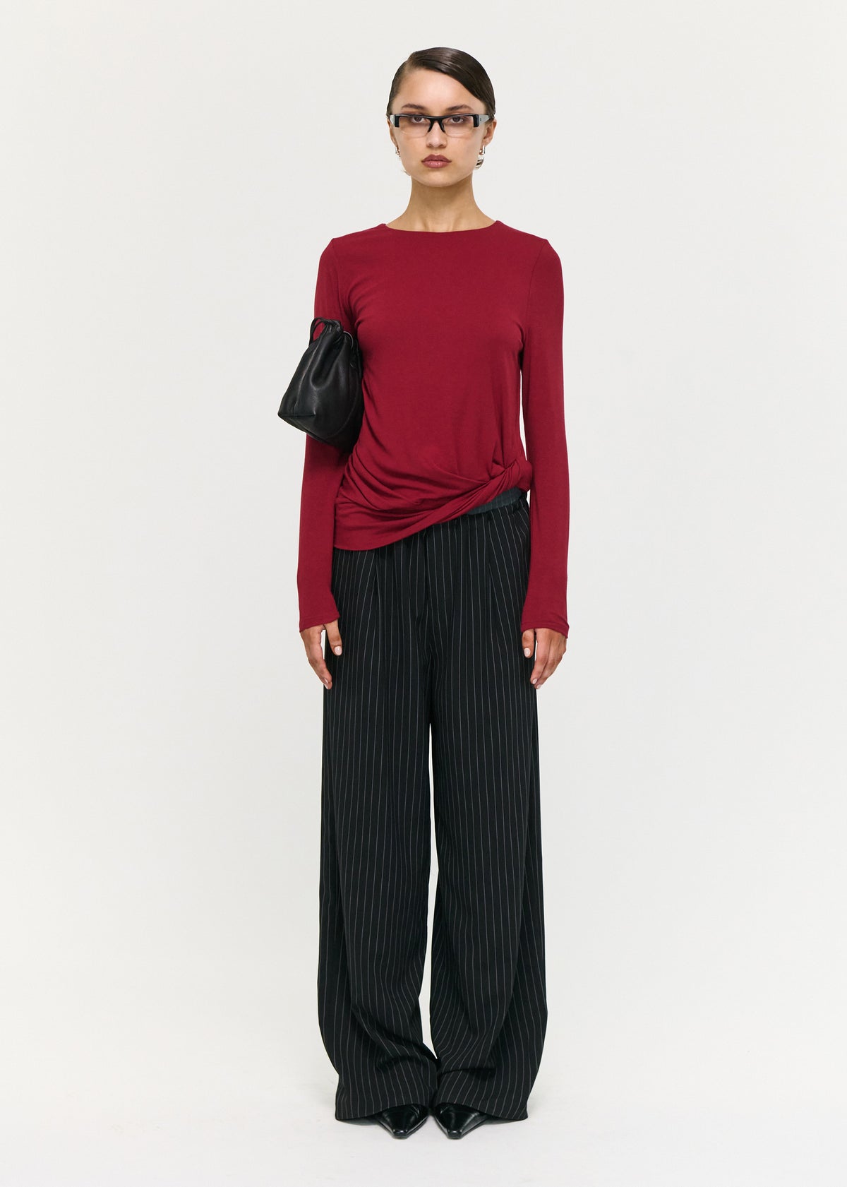 Model wearing Long Sleeve Jersey Twist Top in Merlot with a round neckline and long sleeves.