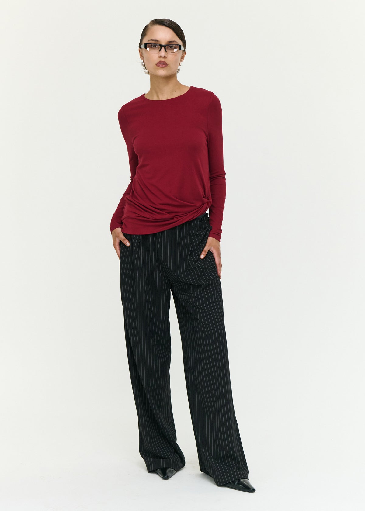 Model wearing Long Sleeve Jersey Twist Top in Merlot with a pull-on style and a soft stretch fabrication.