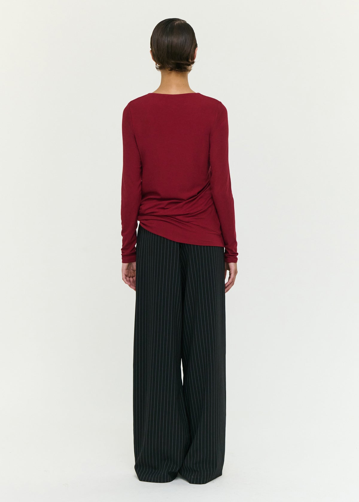Back view of the Long Sleeve Jersey Twist Top in Merlot with a soft stretch fabrication and a relaxed fit silhouette.