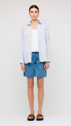 Model wearing Blue Stripe Cotton Oversize Shirt paired with denim shorts on a neutral background.