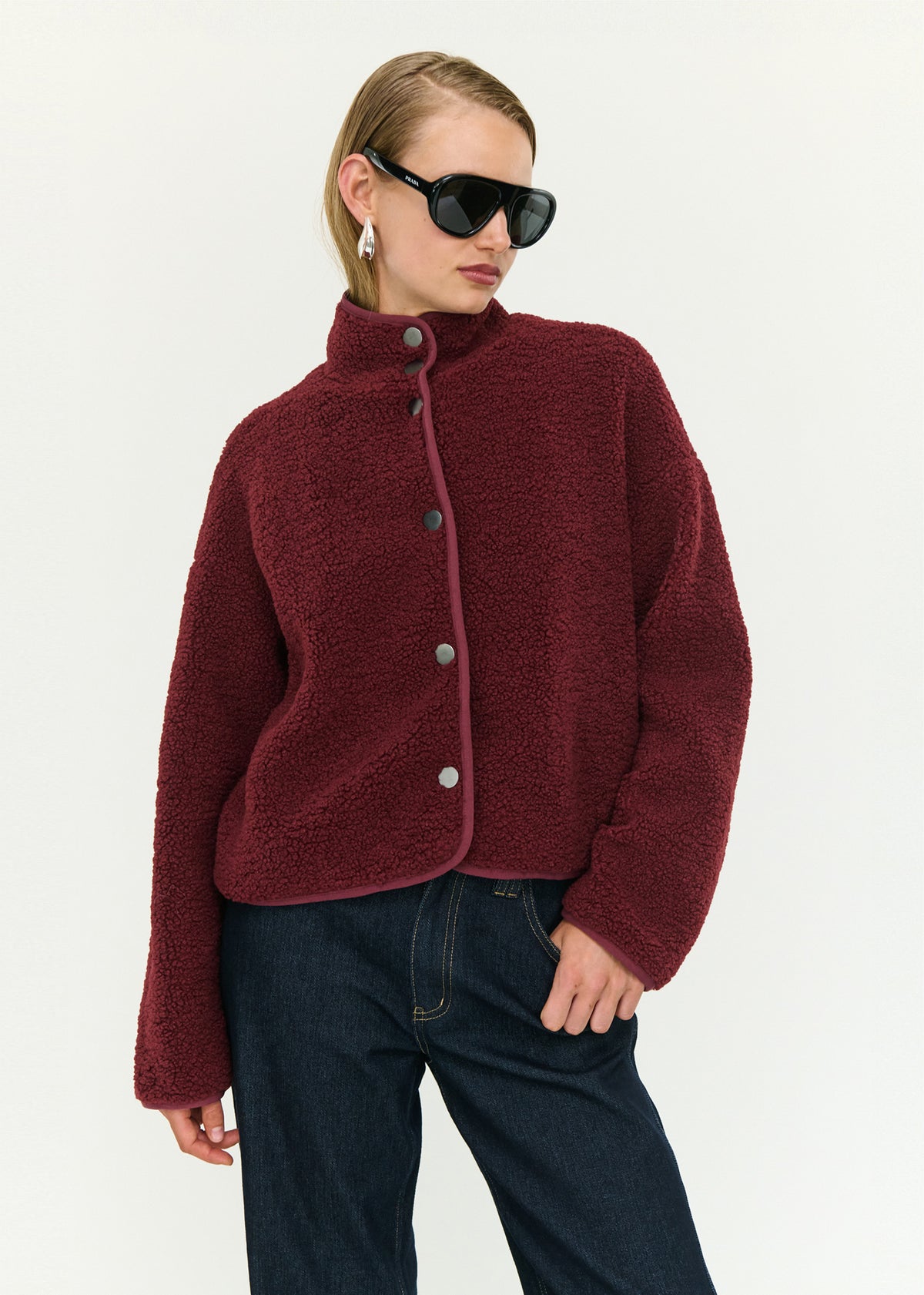 Model wearing Merlot High Neck Cropped Sherpa Jacket with a soft sherpa fabrication and a cropped silhouette.